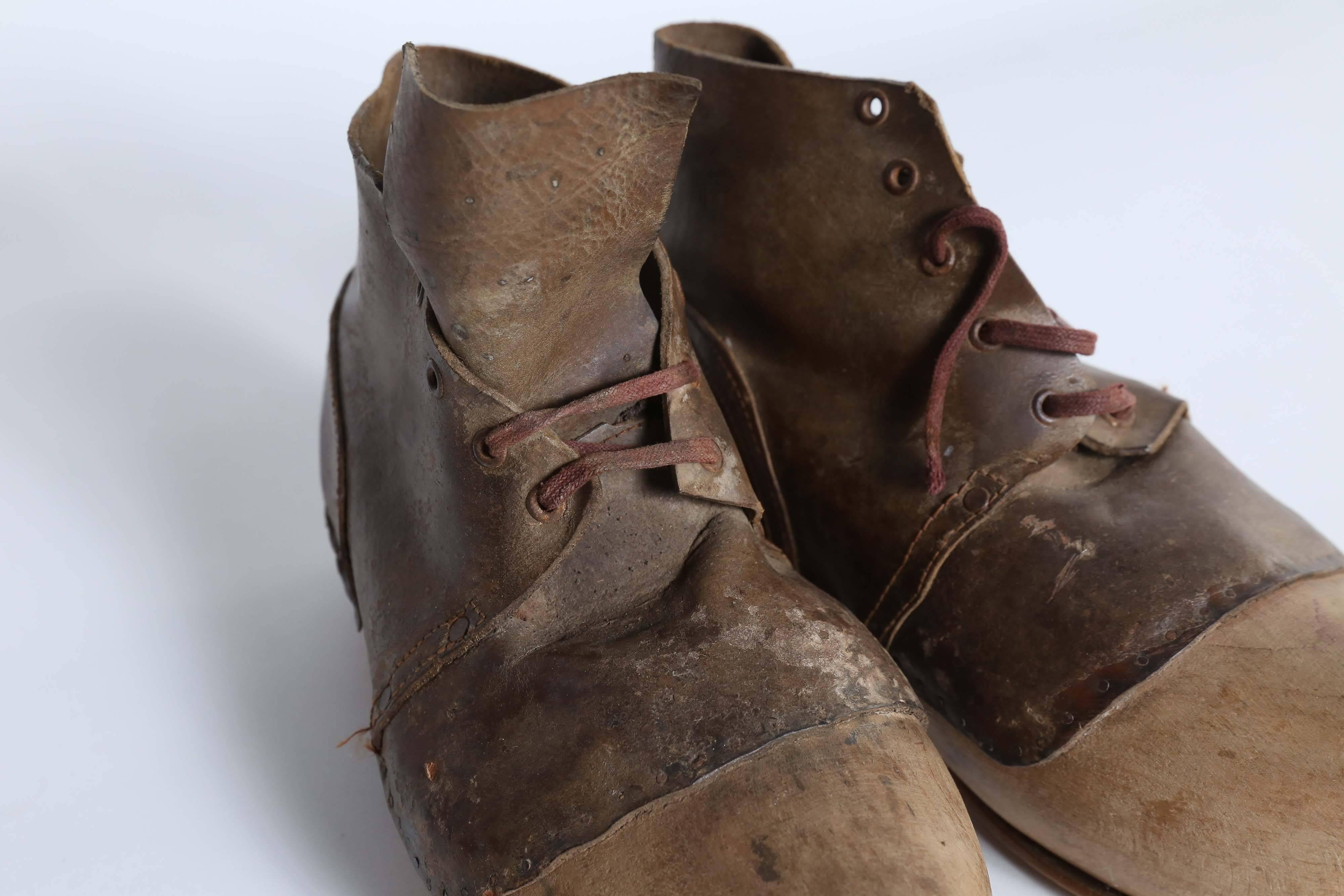 Found in France, an old pair of wooden shoes with leather soles and uppers. The soles and uppers have been applied with tacks. Curious and fun.