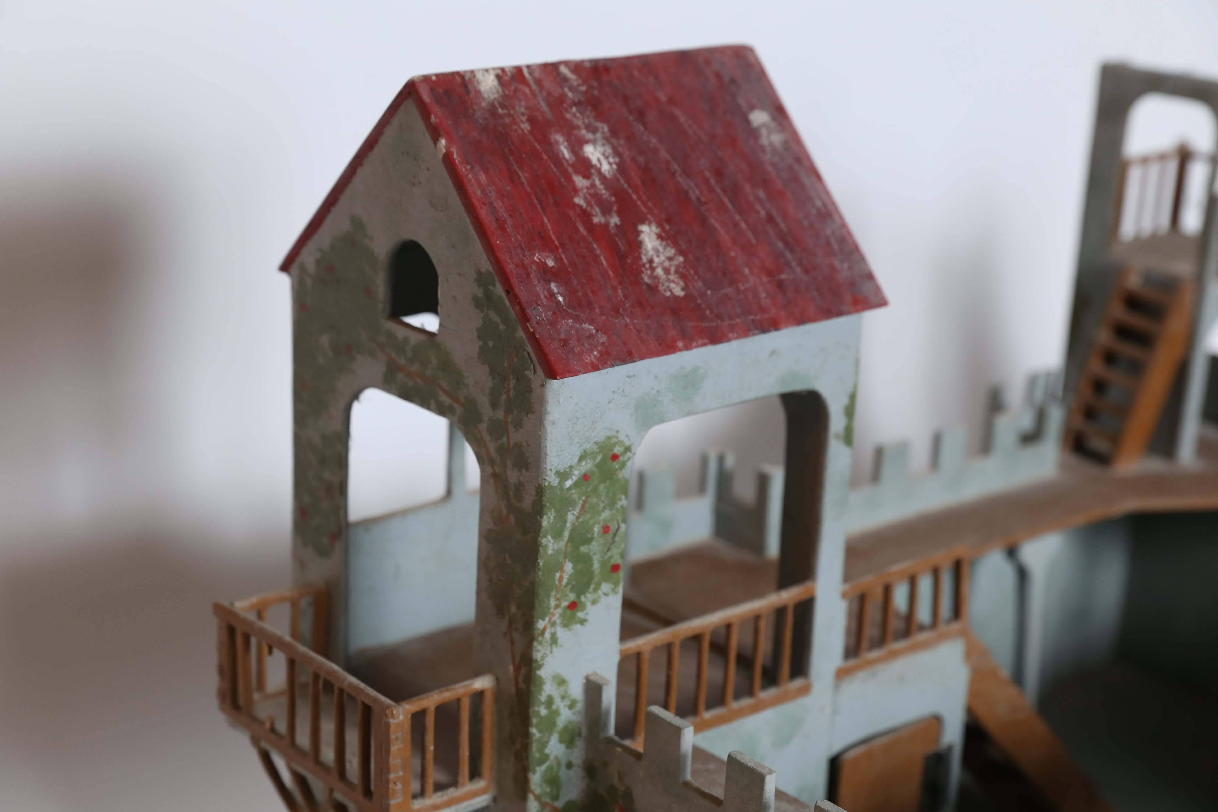 A charming model of a Medieval fort from the Elastolin division of the O.M. Hausser toy company of Germany. Vines and flowers climb the sides of the fort which has a working drawbridge, a bastille, turrets and towers. It comes with an Elastolin