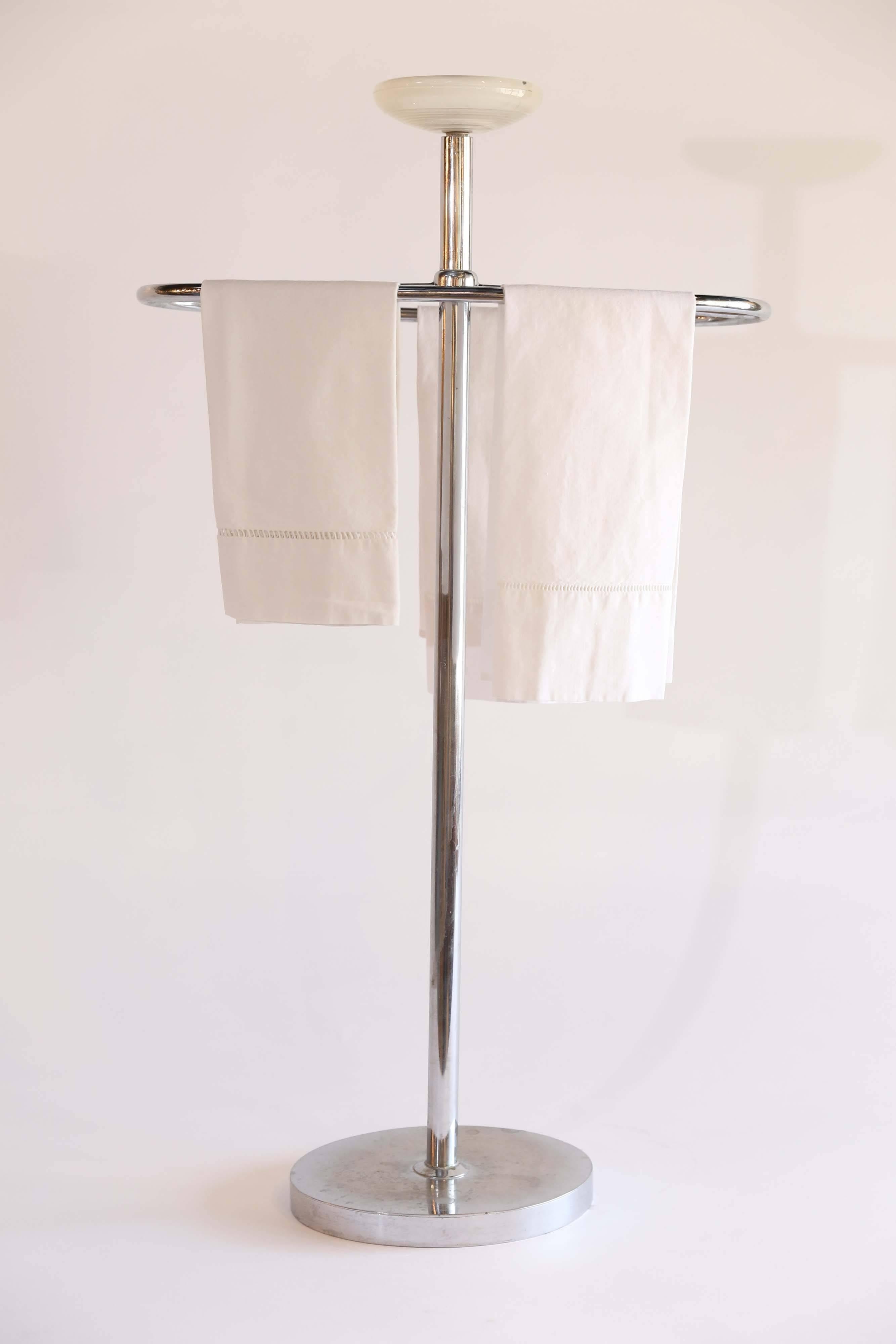 A chrome midcentury towel stand from France with a shaped receptacle of frosted glass on top to hold lotion or other sundries. The base of the stand has dulled with time but the styling of the piece is what truly shines. Smart and sophisticated.