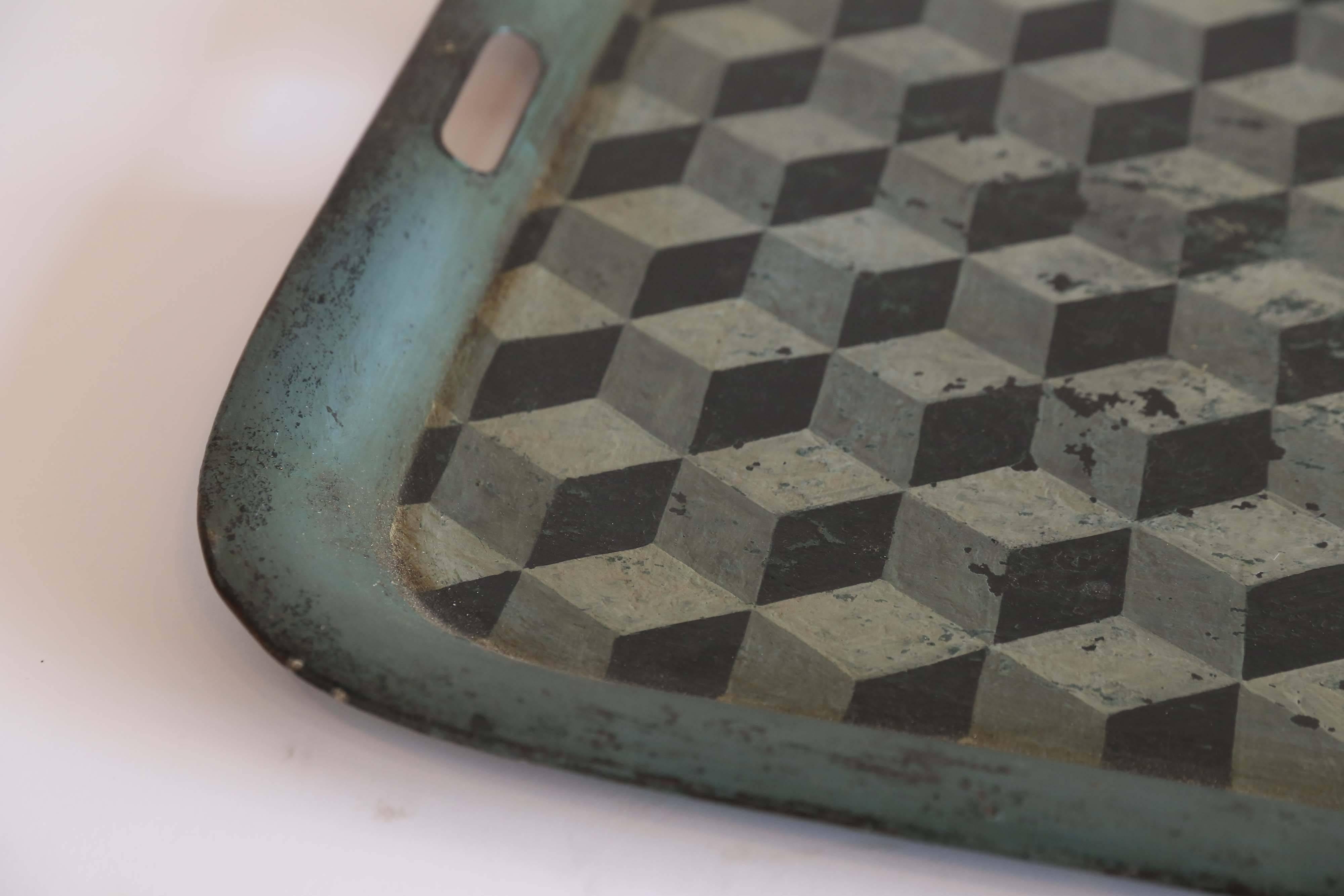 A metal tray of considerable size from 18th century, France. In shades of green with black, the tray is hand-painted in the Tumbling Block pattern. The wear on the piece minimal for it's age. Charming with a high touch factor.