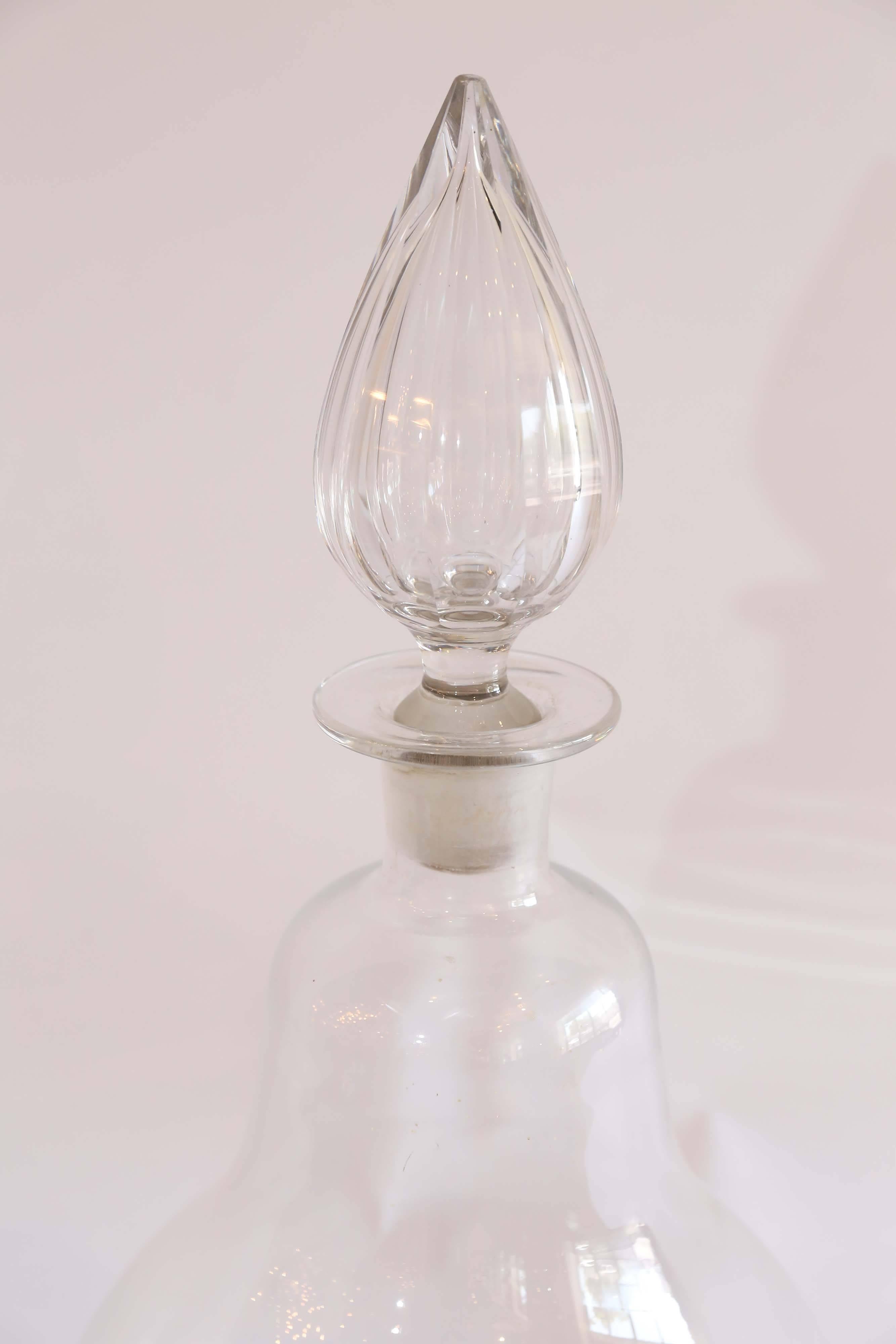 An dramatic and imposing glass apothecary bottle found in France. Grand in size and scale with a massive teardrop shaped glass stopper, this piece is truly dazzling.