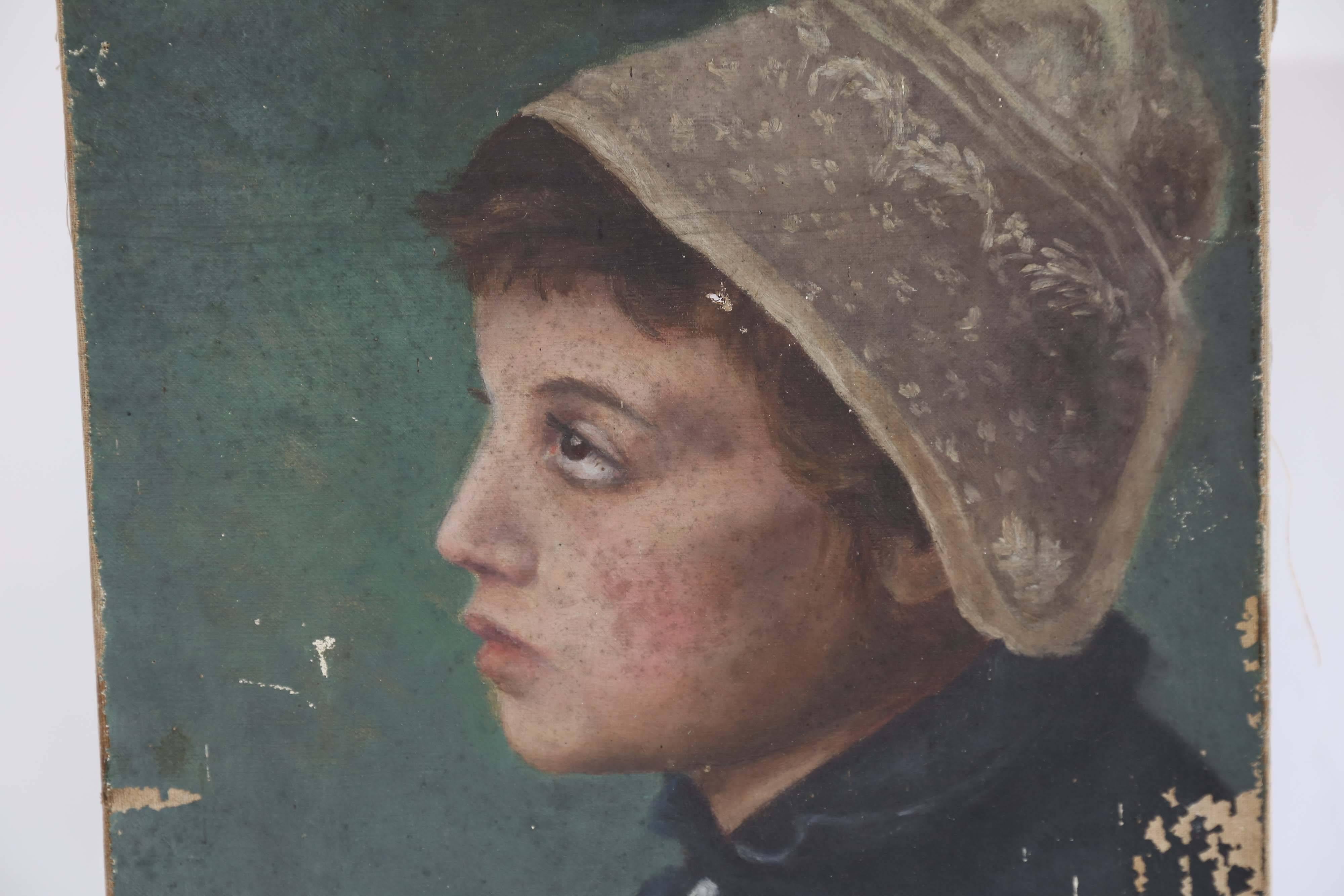 Found in France, an enchanting oil portrait of a young girl. On a dark green background, the wistful maiden wears a dark four-button coat and a lovely lace cap. The painting is unsigned and shows wear confined almost entirely to the outer margins.