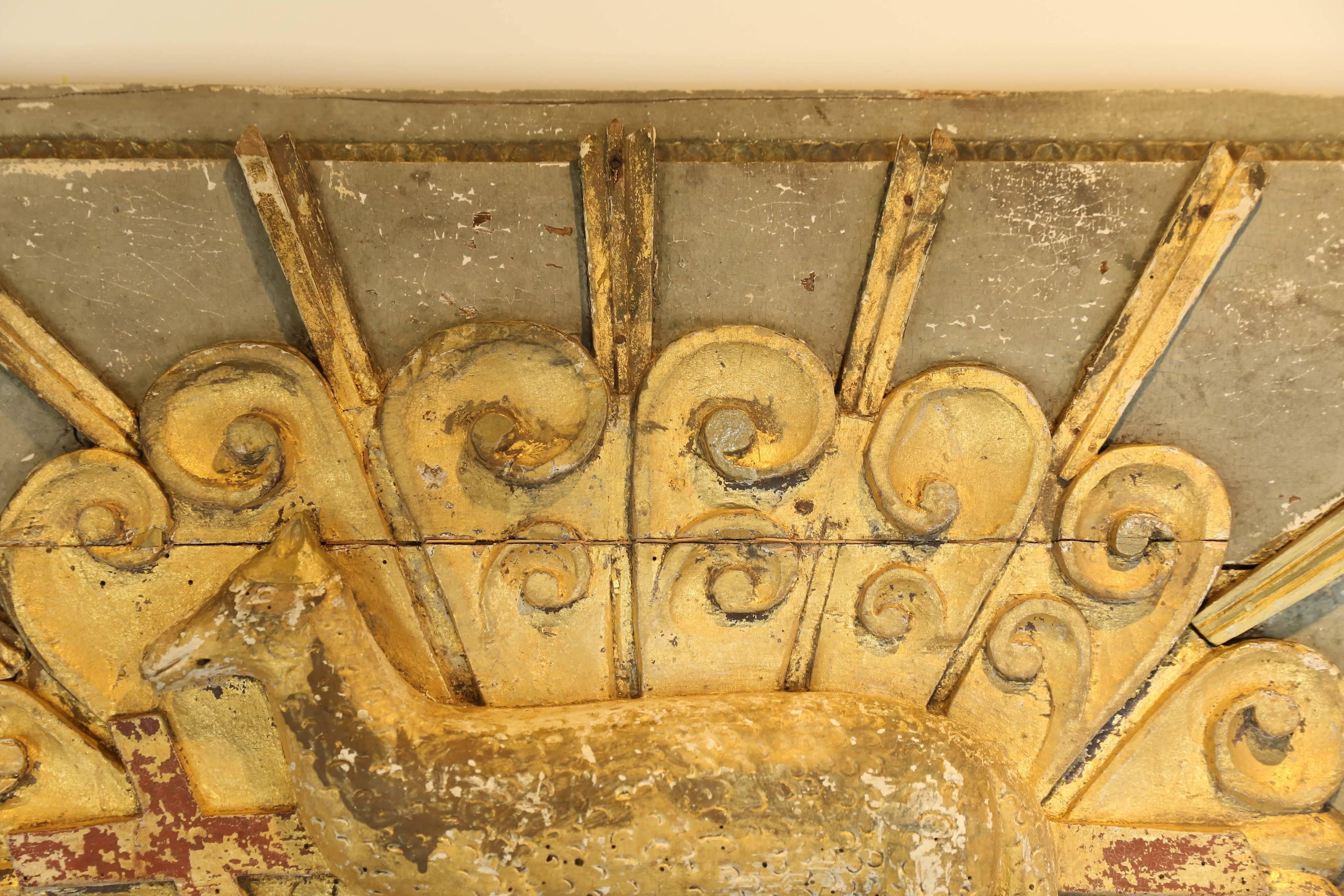 An architectural panel found in France depicting the Lamb of God. Slightly concave horizontally, the panel has gray over white paint with traces of a red undercoat on the cross and with all decoration in the original gold leaf. Truly a special find.