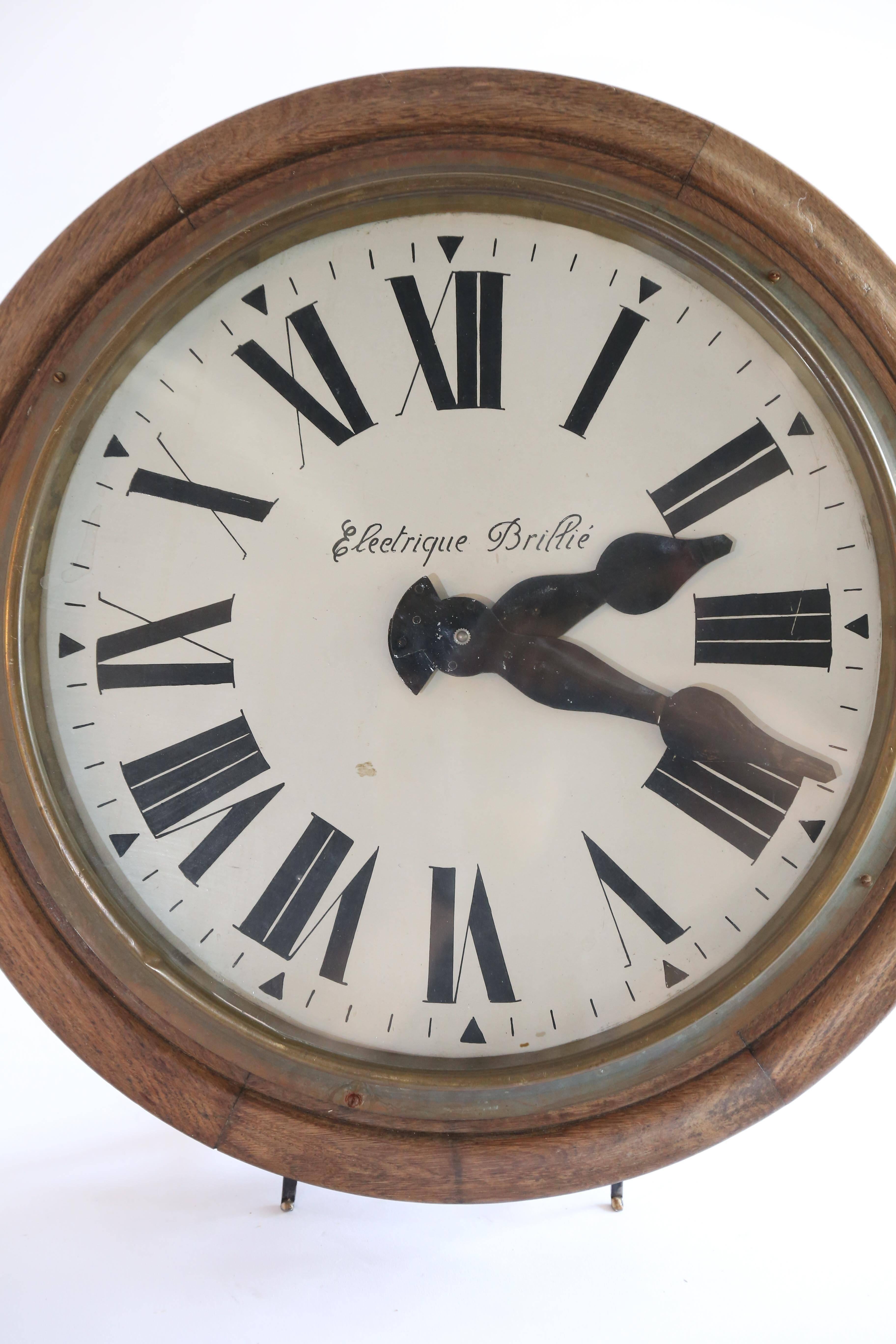 An iconic Electrique Brillie wall clock. This original French factory clock was manufactured by Brillié in the 1930's. With a body of sectioned oak, it has a white painted face with bold black Roman numerals and equally bold black steel hands