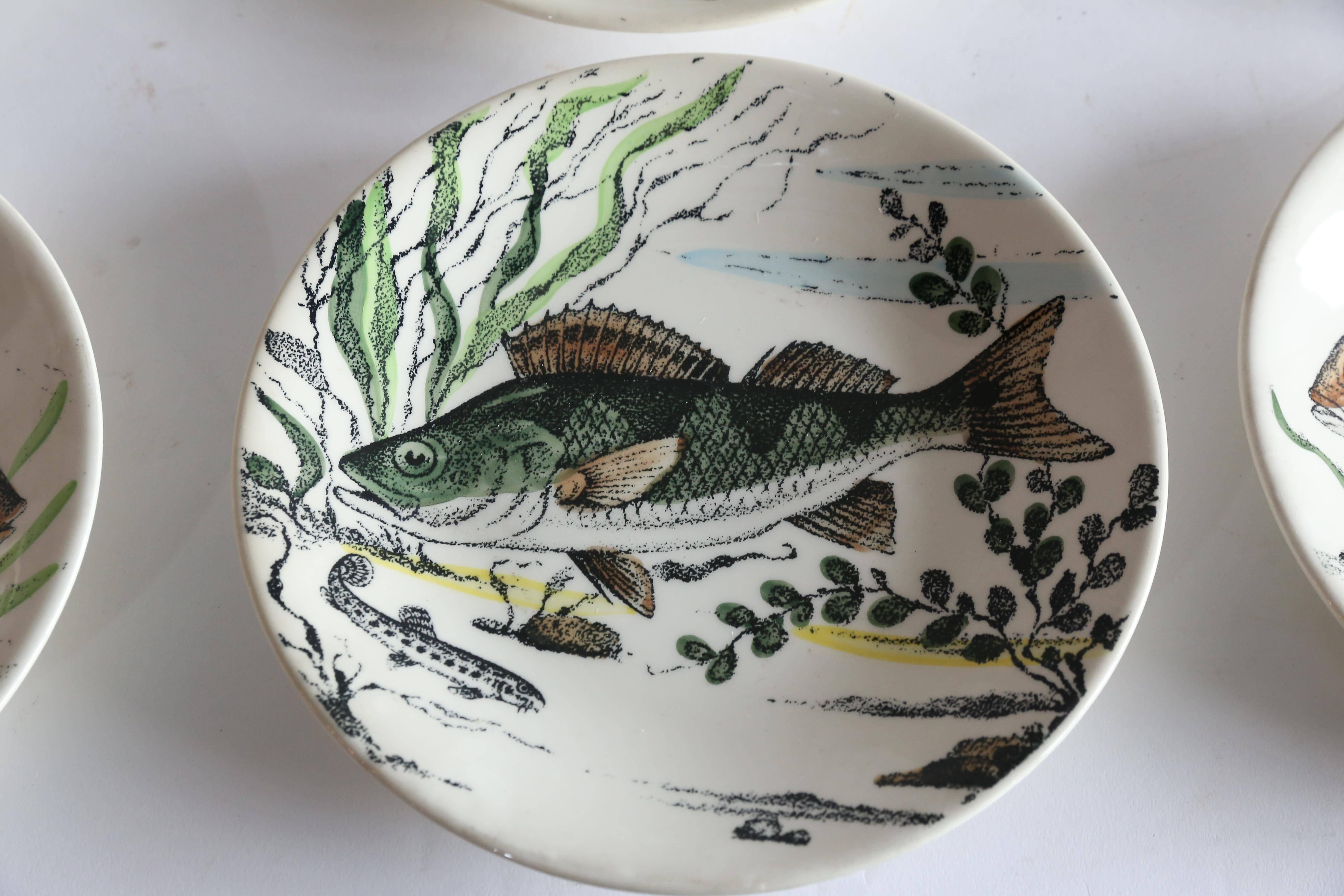 Six river fish, two of each, swim on the surface of this 12-piece set of plates from Gien of France. Charming and fun. Dishwasher safe.