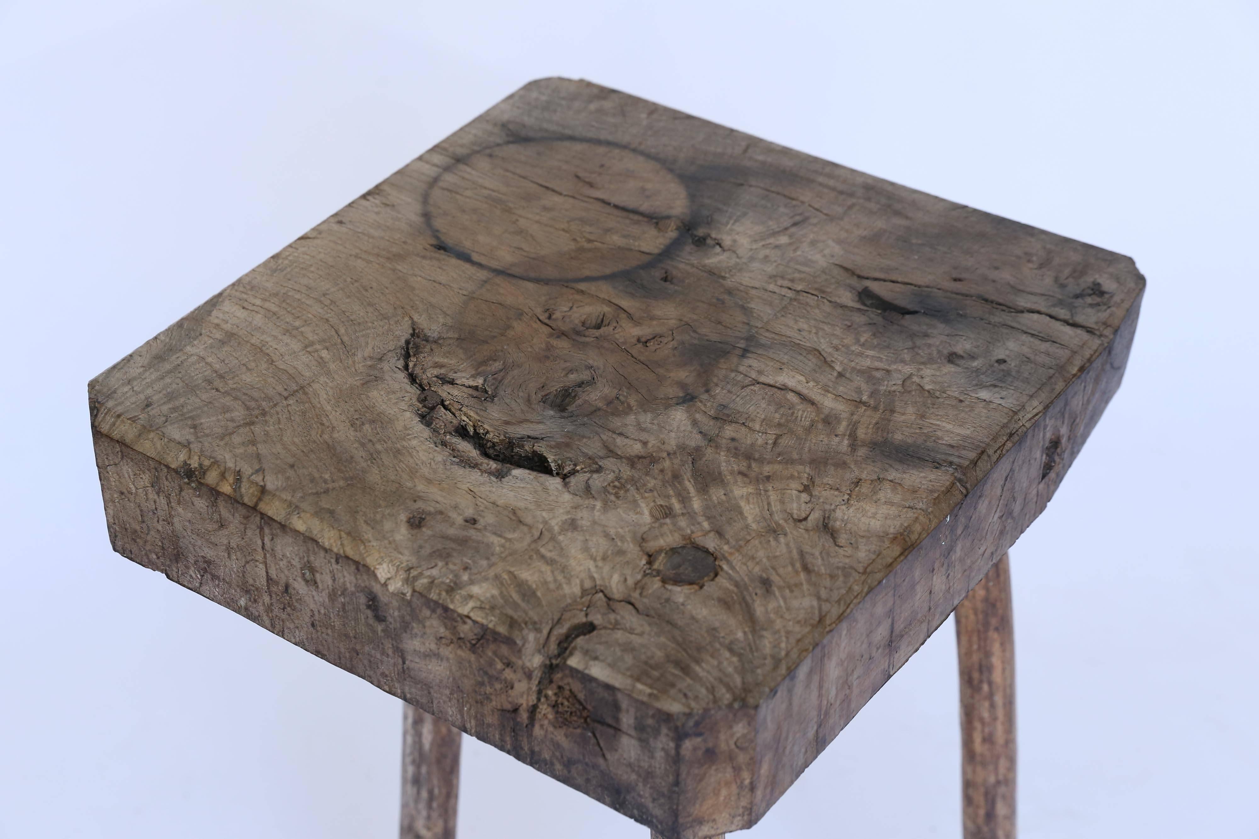 A quirky rustic three-legged table found in France. Heavy and amazingly sturdy, a treat for the eye from every angle. The 3 inch thick top is the focal point where, along with the natural interest of the wood, the end of one of the legs is apparent