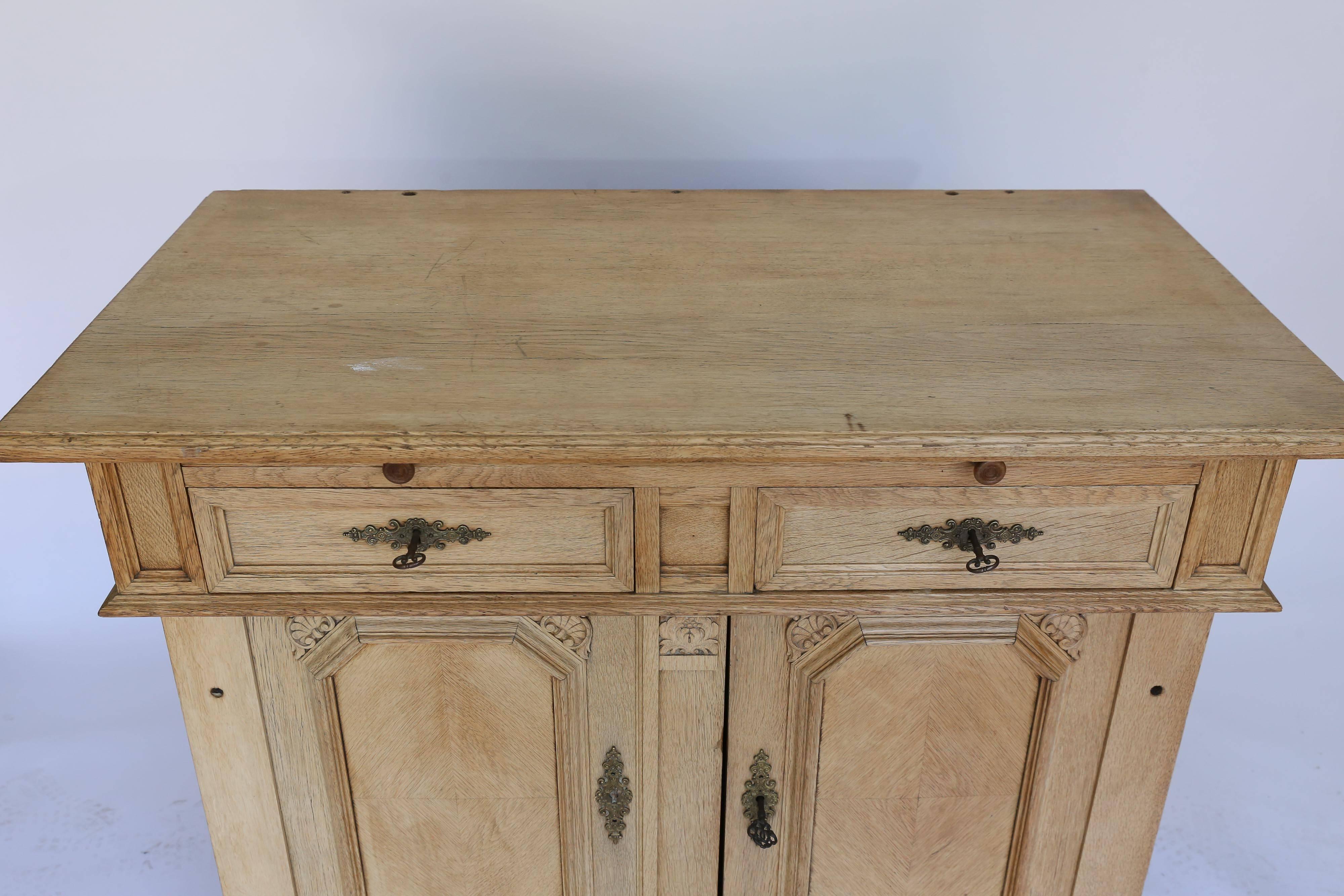 A striking kitchen cabinet from France made of pine that has been stripped. With applied wood trim and detailing and a diamond veneer pattern framed out on the doors, this piece has wonderful eye appeal. Two drawers and two doors open for lots of