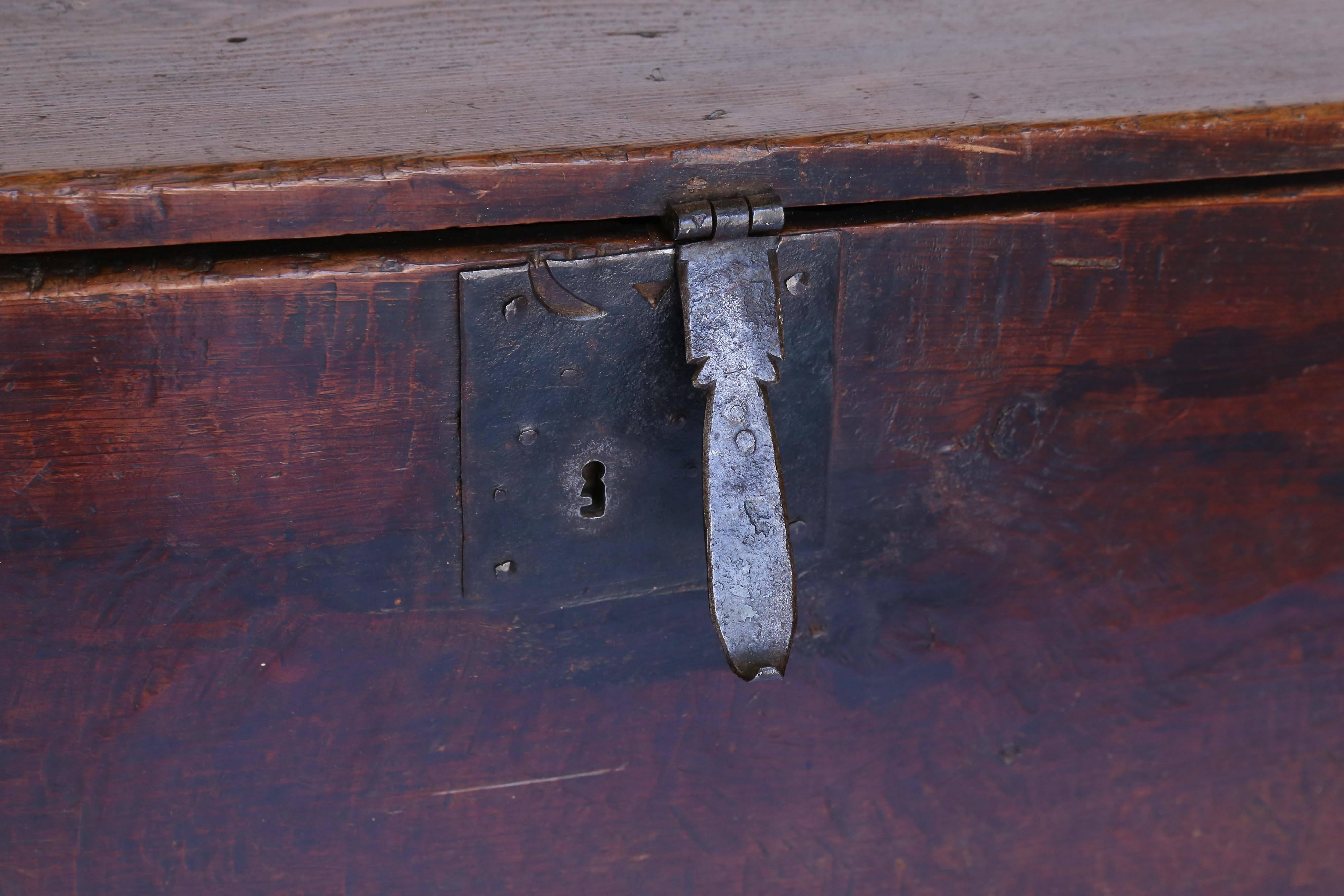 A large Spanish trunk from the 17th Century in dark stain with original iron hinges and escutcheon. Striking dovetail joinery and the beautiful color and patina of the surfaces add to the warmth of this piece. Strong and sturdy with only expected