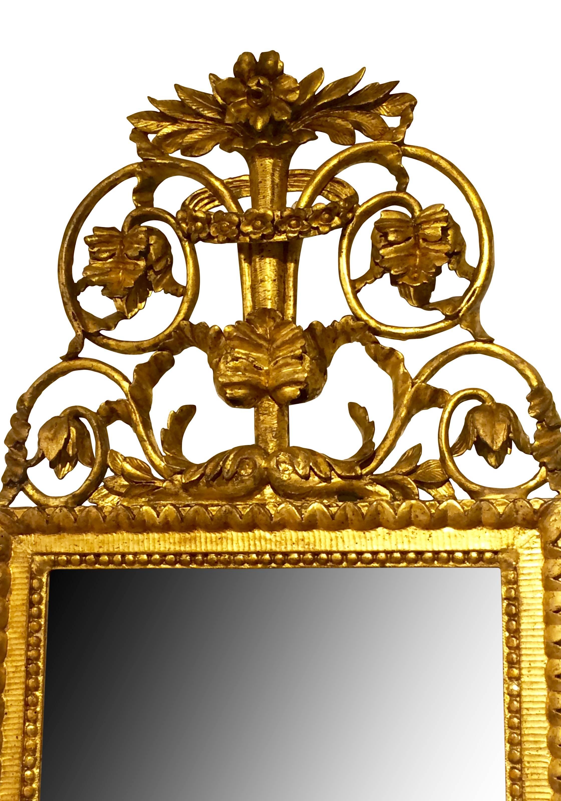 Mirror frame um 1780, with leaves and flowers as crowning. Lindenwood carved with original gilding, Austria. Measures: 95 cm high x 42 cm wide.