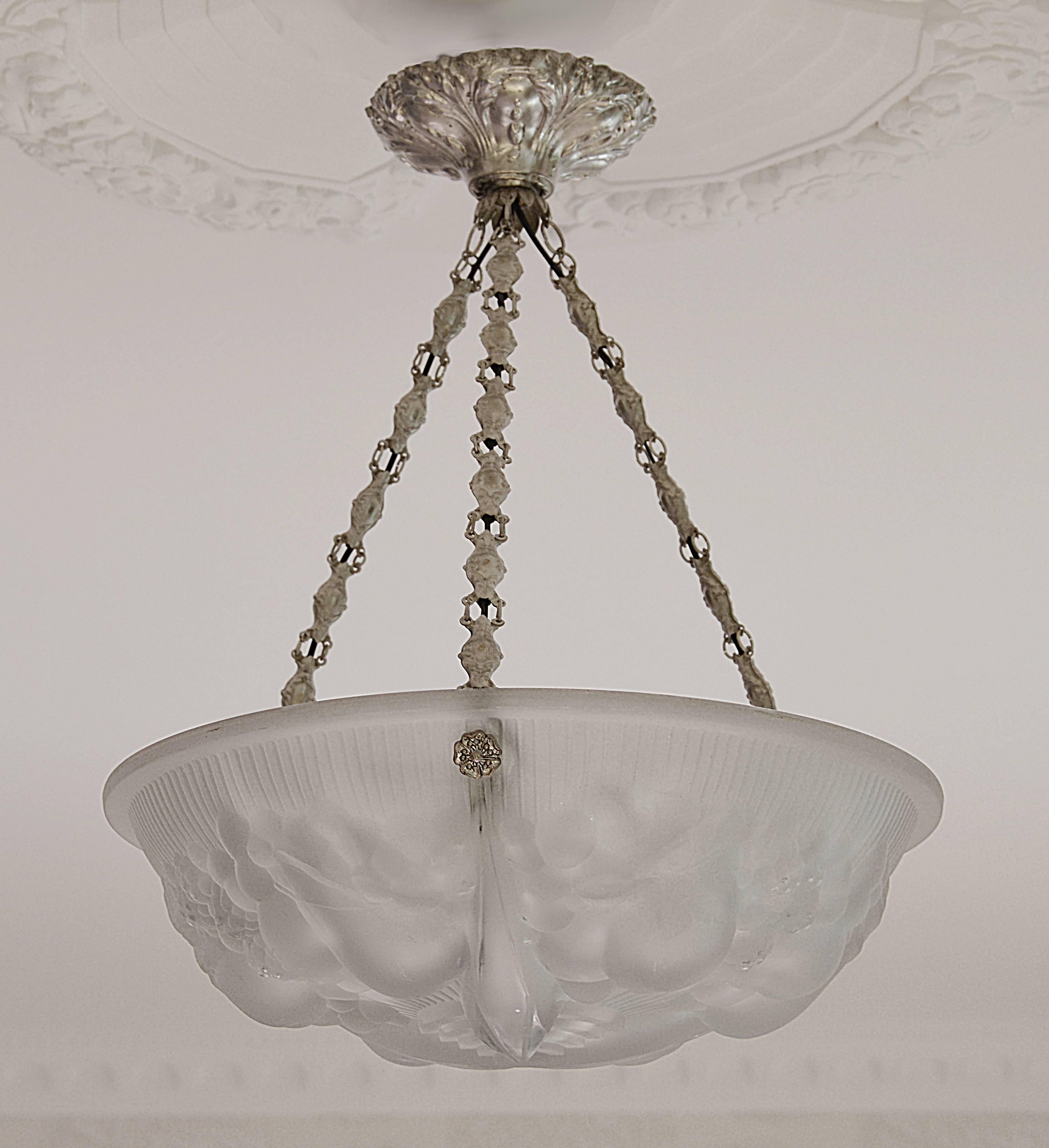 French Art Deco chandelier by Muller Freres, Luneville, France, circa 1925. Thick frosted molded glass shade with a fruit pattern hung at its original silver plated fixture. Some slight flaws inherent to the technic of this period. Molded signature