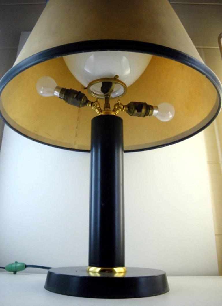 Large table lamp by Jacques Adnet, France, late 1940s. Leather, brass and parchment. Parchment and green leather of the shade are hand-sewn (see photo). A white glass reflector under the parchment shade. Three B22 sockets. One inside the reflector.