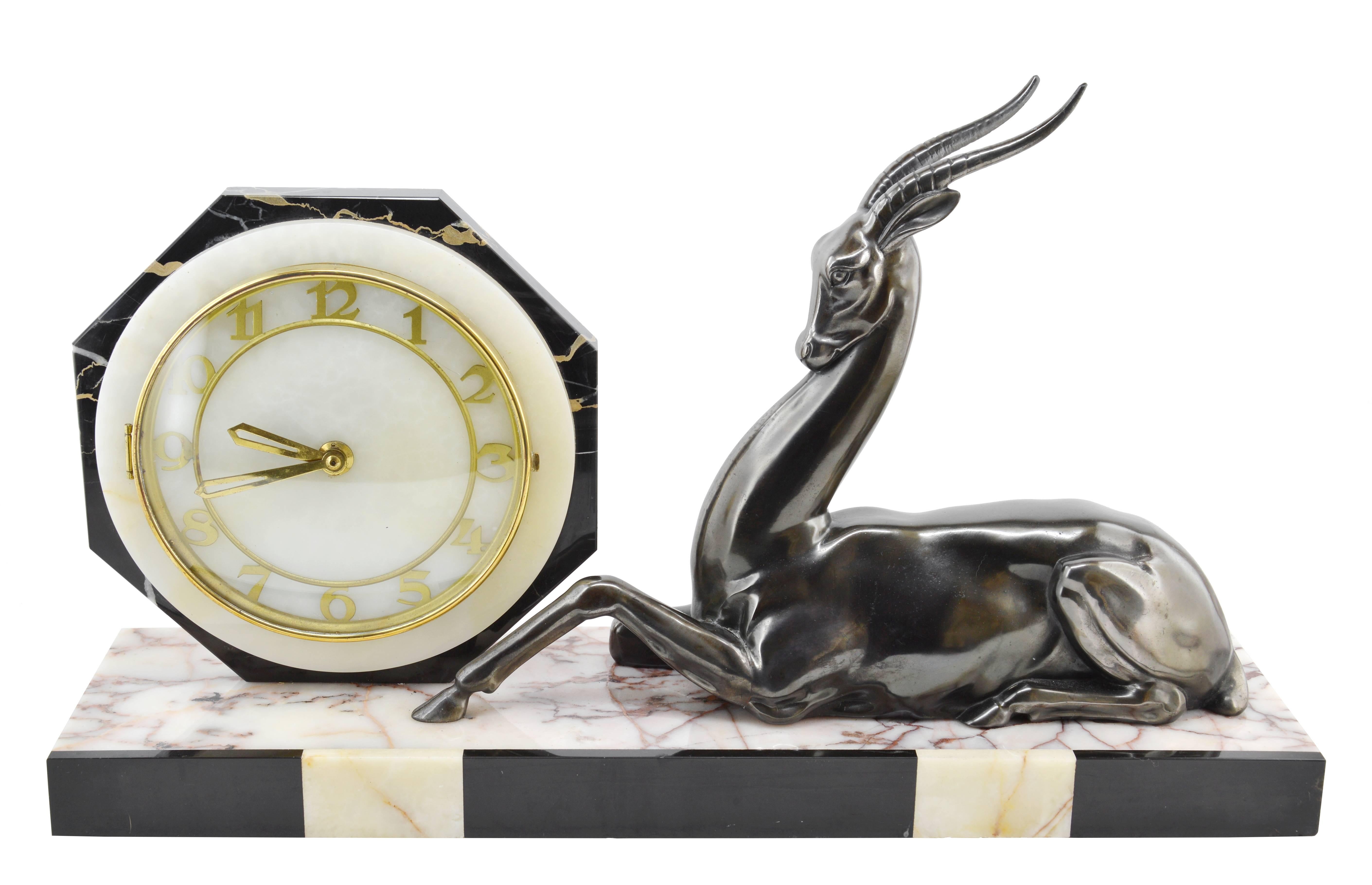French Art Deco clock, France, circa 1925. Spelter, marble, onyx, brass and glass. Spelter antelope. 8 days movement.