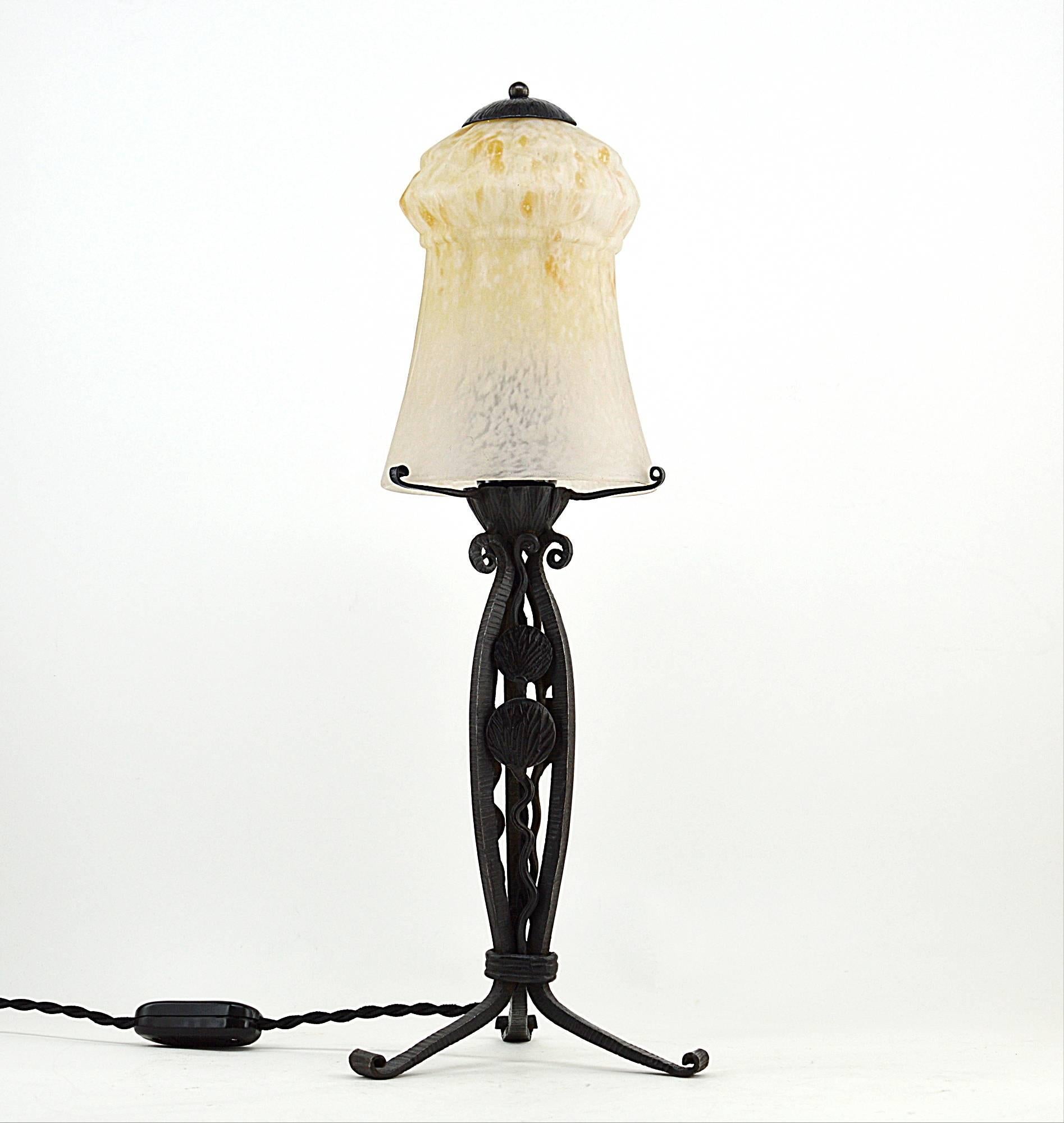 French Art Deco table lamp by Charles Schneider (Epinay-sur-Seine, Paris), circa 1925. We have a pair. Superb mottled blown or molded double glass shades whose colors are white and ochre. Genuine wrought iron bases. They are not absolutely