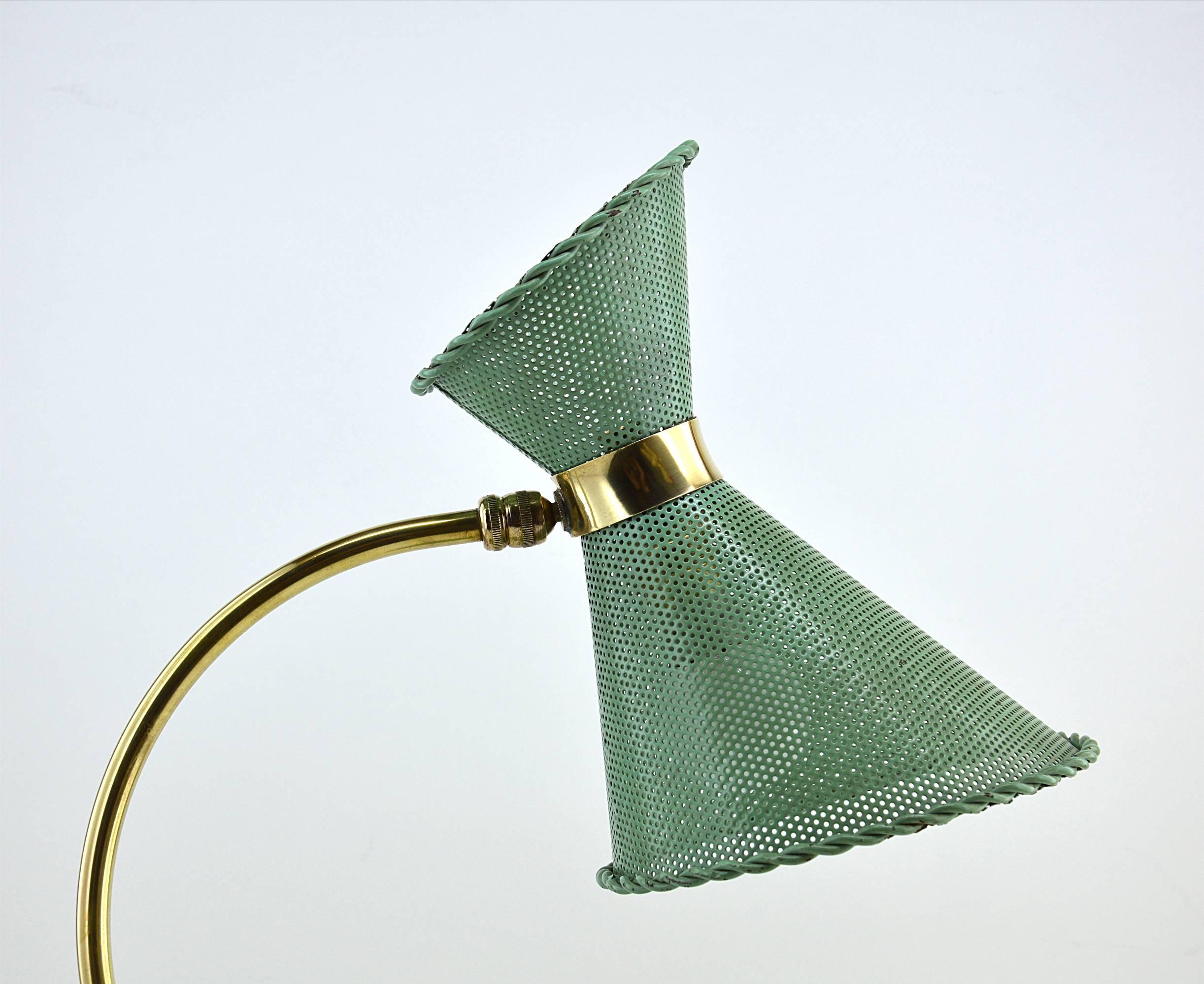 Vintage desk or table lamp in the manner of Mathieu Matégot, France, 1950s. Made of brass and perforated metal. Nice original green paint. Sometimes this lamp (or very similar ones) is introduced as by Mathieu Matégot and other times as in the
