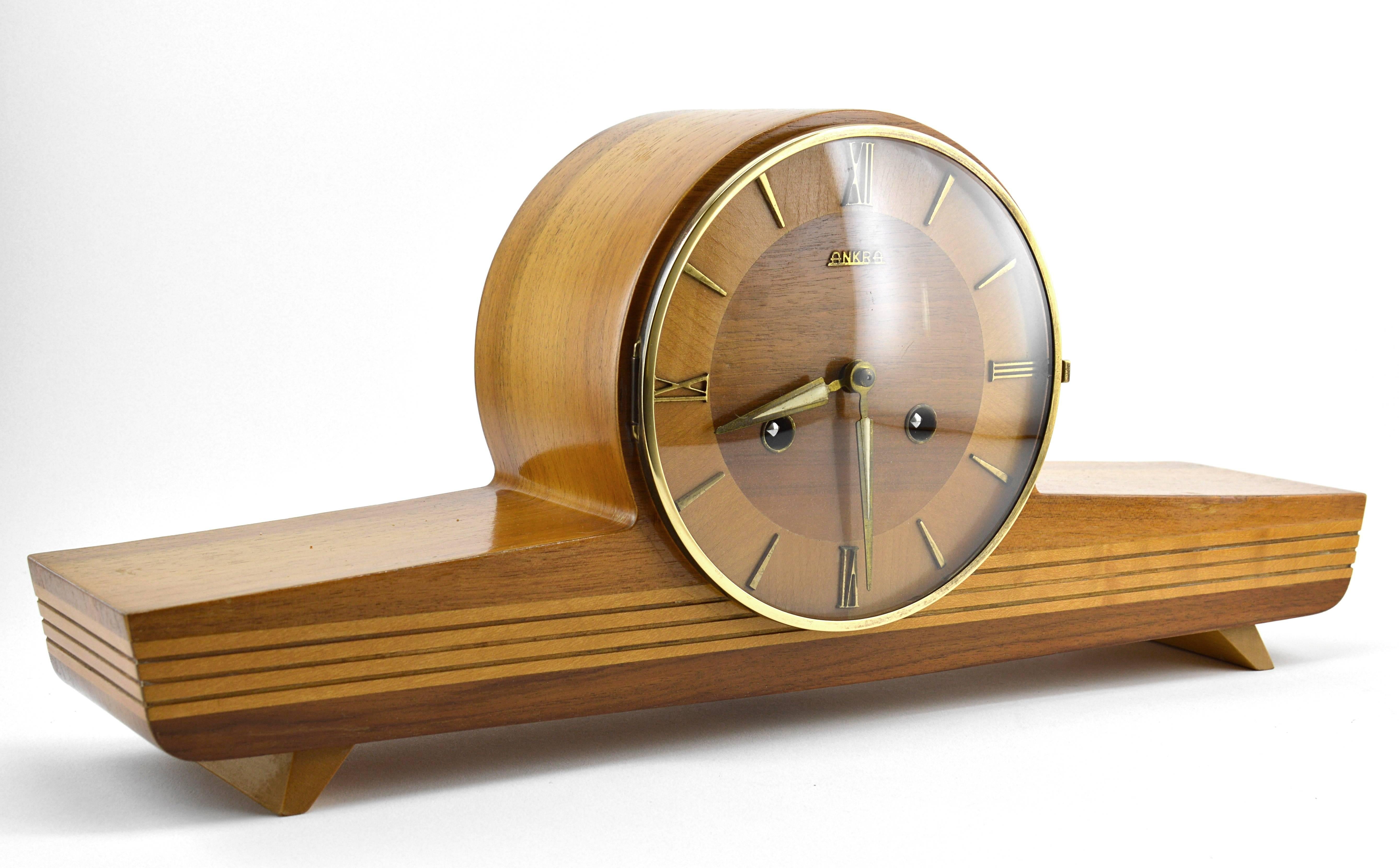 German midcentury clock, circa 1950. Wood, brass and glass. Original beveled glass. Comes with its key. Original mechanism. Keeps good time. Chime ok.
 