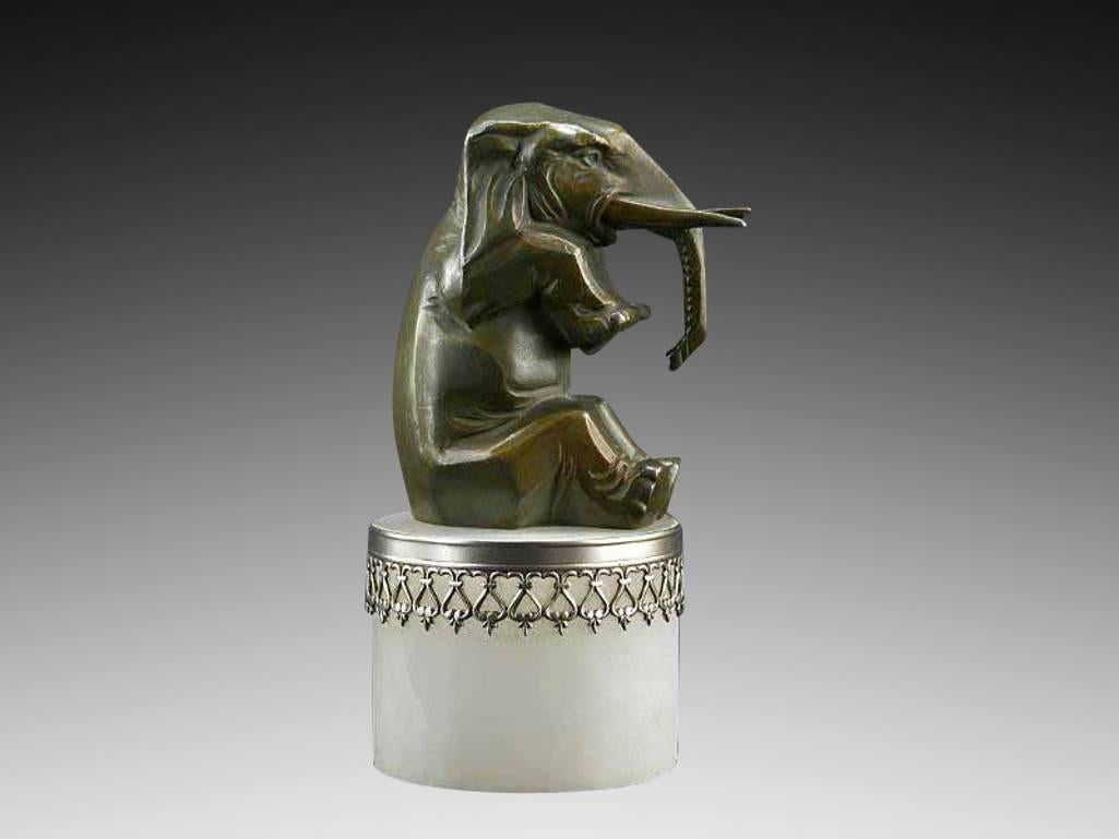 French Art Deco elephant paperweight sculpture, France, circa 1930. A circus elephant sat on a drum. Spelter, alabaster and silver plated metal.

 