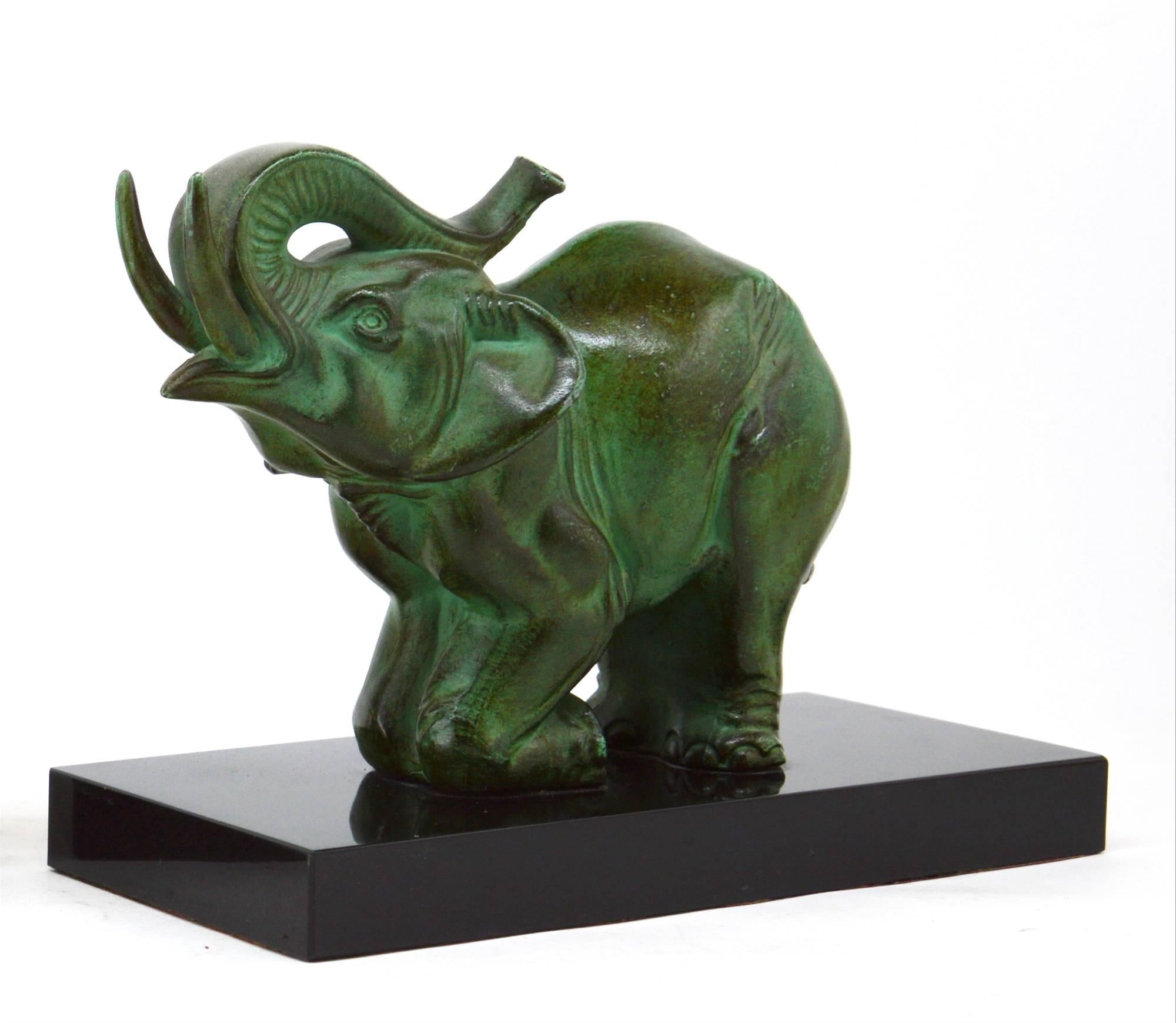 Beautiful pair of bookends by Louis-Albert Carvin, France, 1920s. Both spelter elephants wear their original green patina. They rest on their black marble base. One of them is signed 