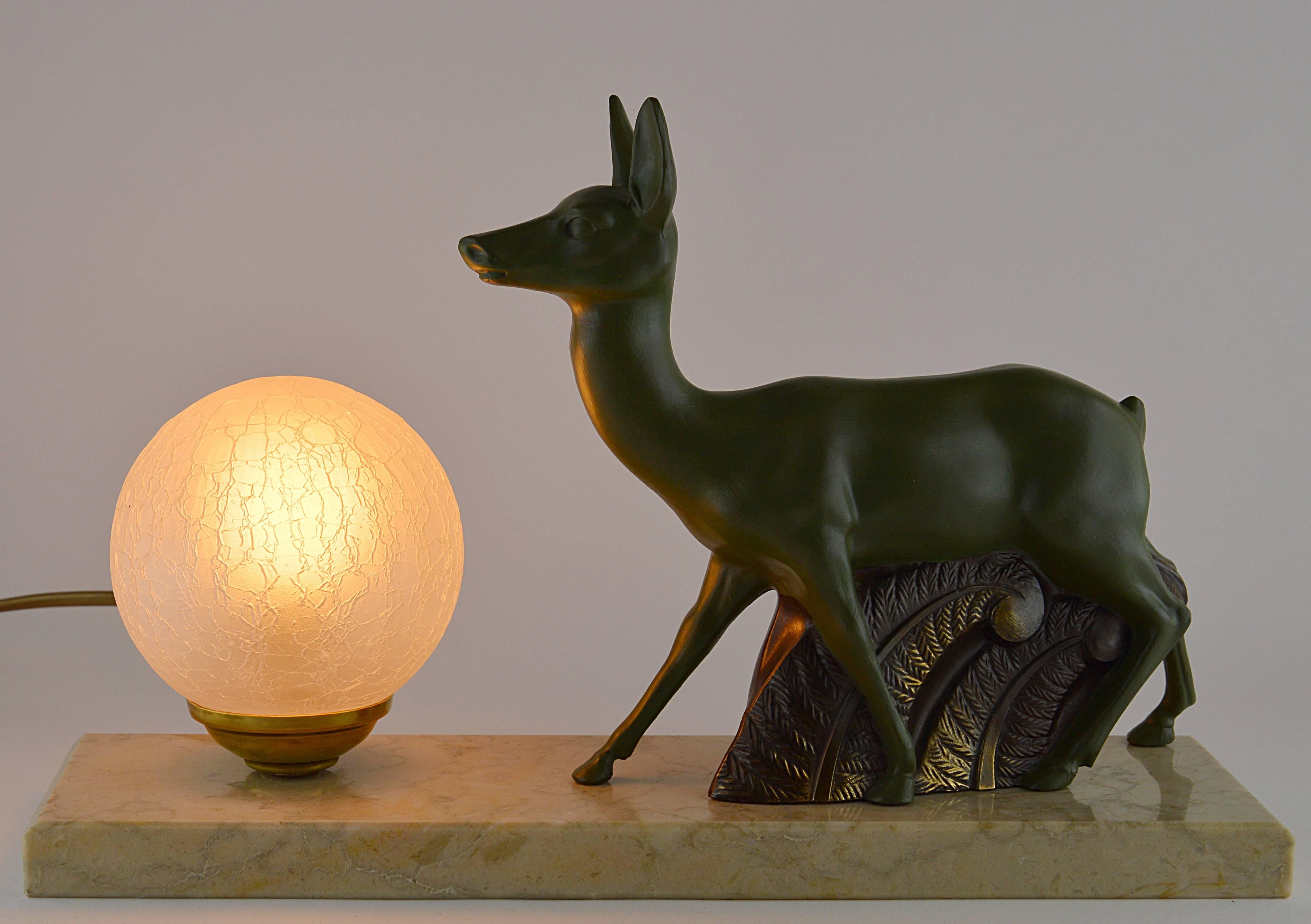 Take advantage of our nice summer prices. French Art Deco antelope table lamp or night-light sculpture, 1930s. Made of spelter, marble and glass. Cold-painted spelter antelope. Reticulated glass shade. Marble base. Delivered wired with a bayonet