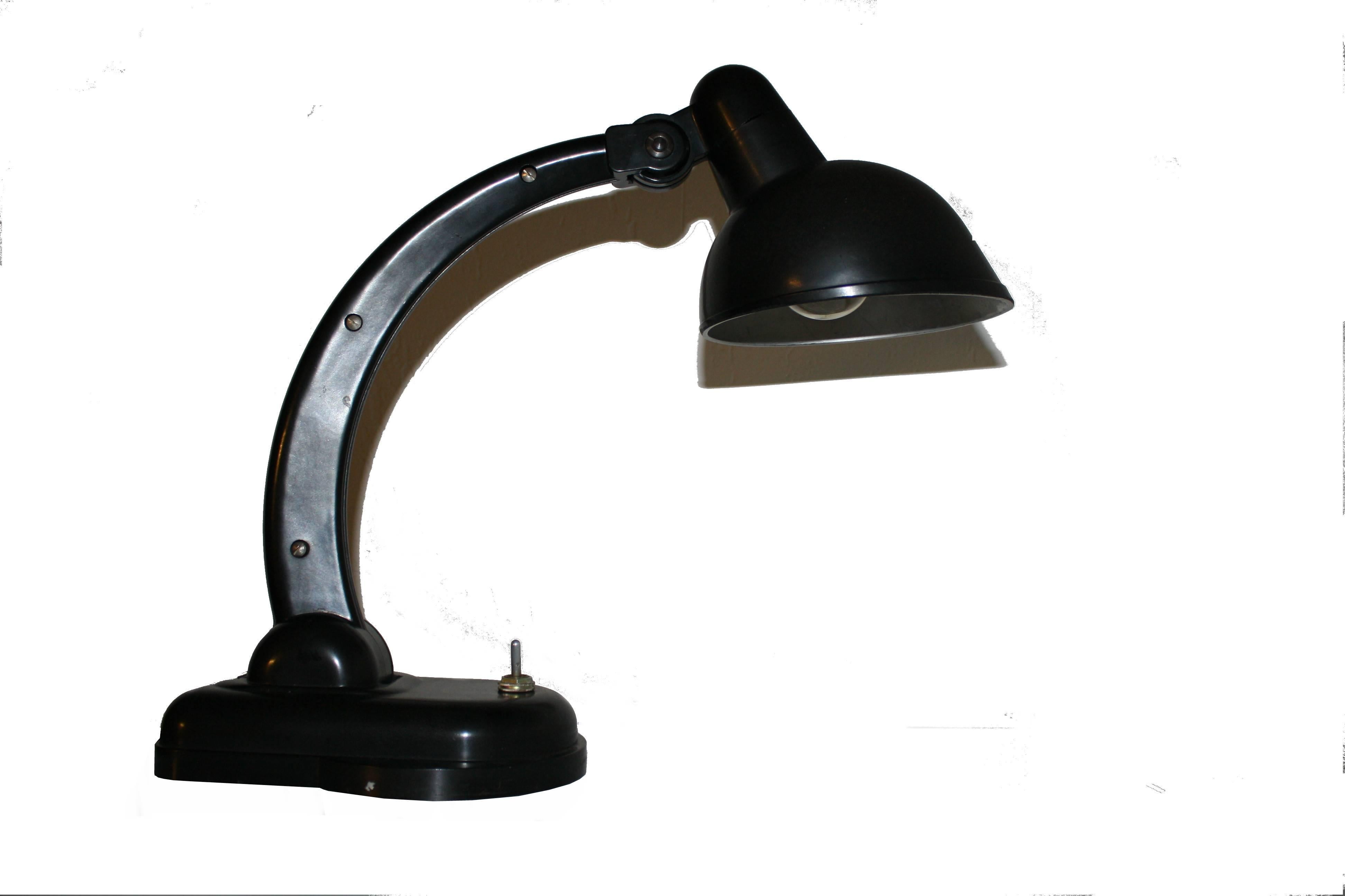 Beautiful bakelite desk lamp from Soviet origin, marked underneath.
​
This lamp was designed by Christian Dell who is well known for Bauhaus style lamps. This model is called Sigma.
​
The lamp is in a used condition with discolouring on the