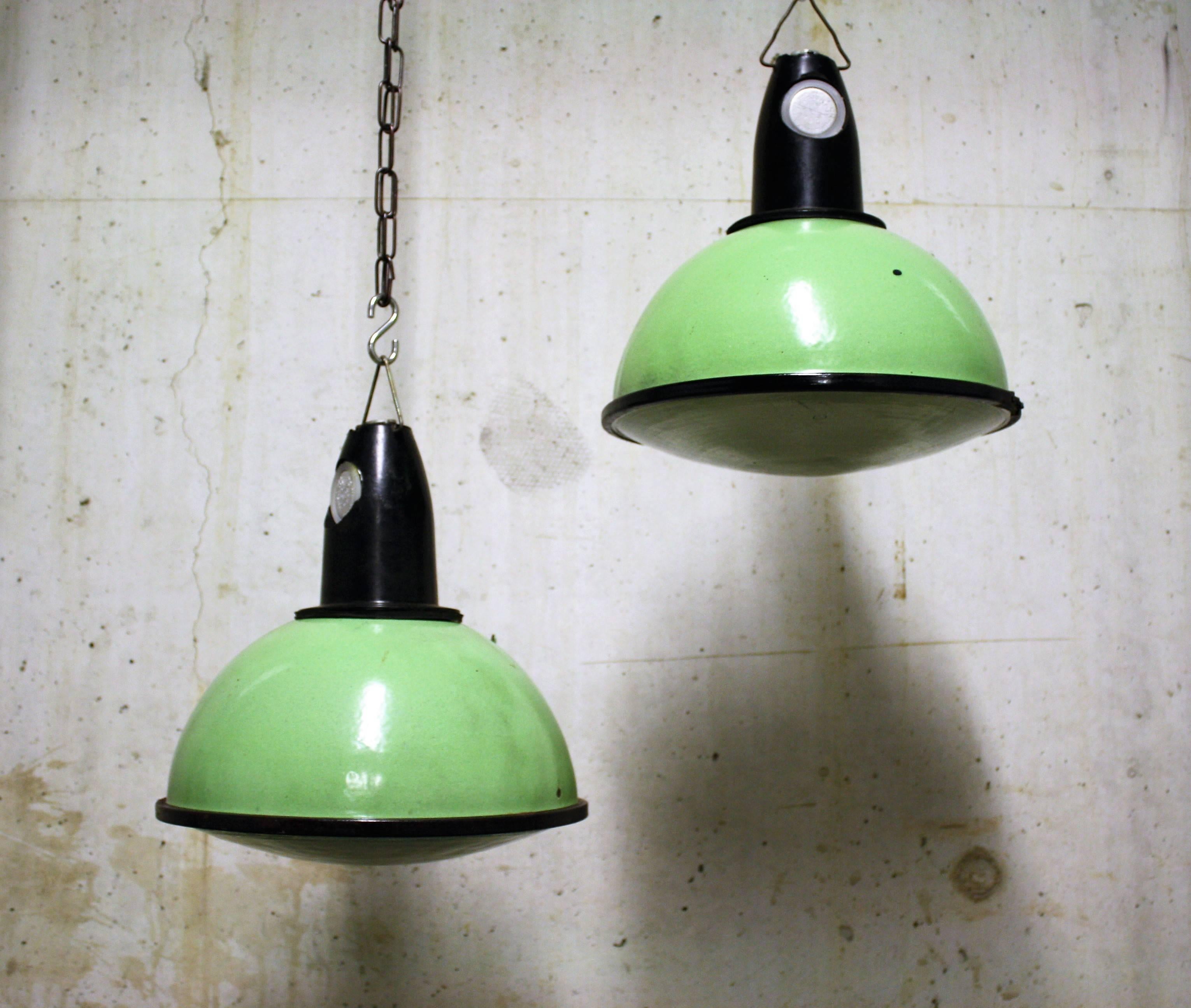 Vintage Industrial pendant lights with glass in green enamel.

These lamps look wonderful in their original green colour, the prismatic glass give a lovely warm feeling once the lamps are illuminated.

The shades are in very good condition, show