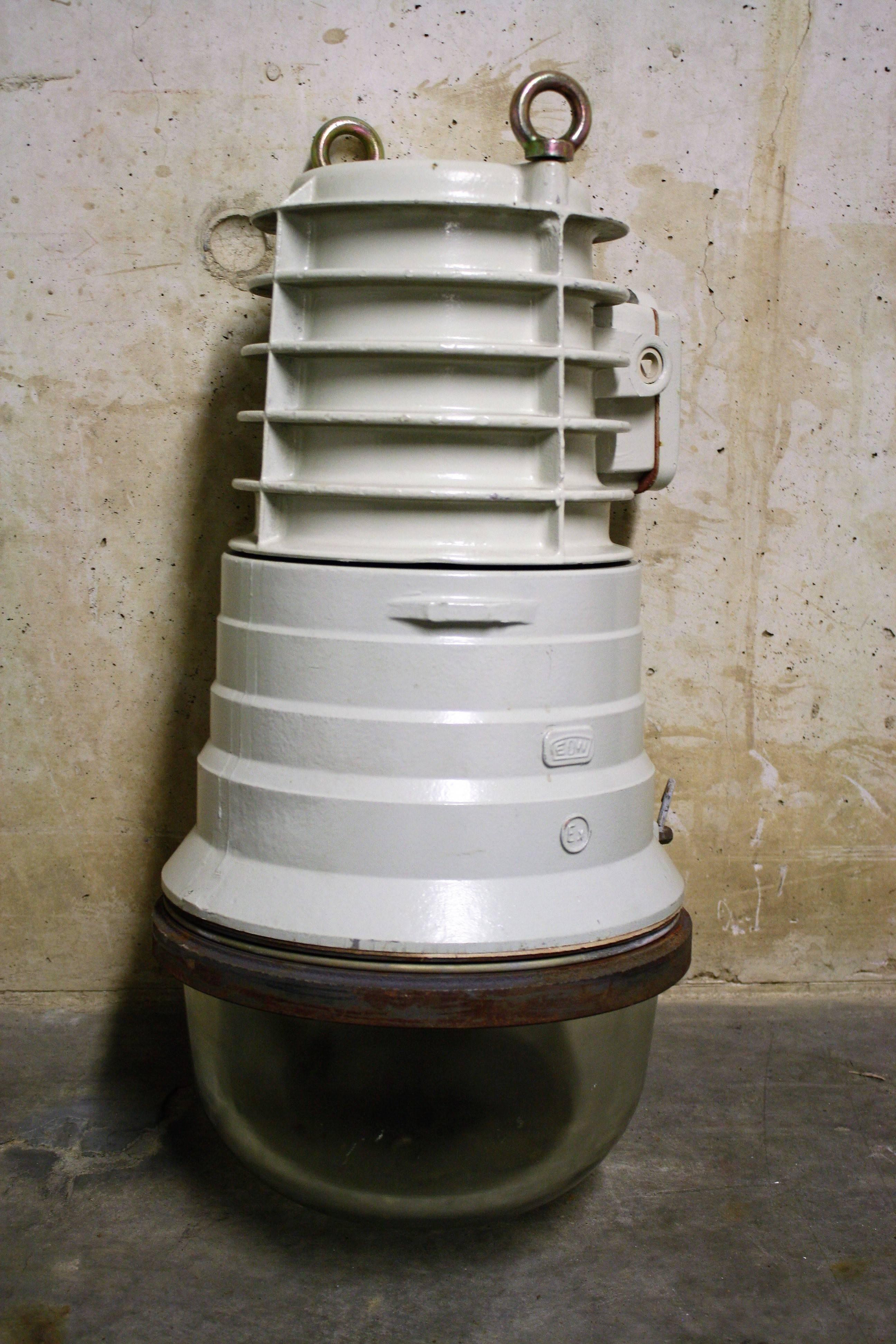 Large grey Industrial explosion proof bully lamp, marked EOB, a German manufacturer of Industrial lamps.

The lamp is made from cast iron and very strong glass.

This huge German lamp was used in chemical industry. They are purpose built so they