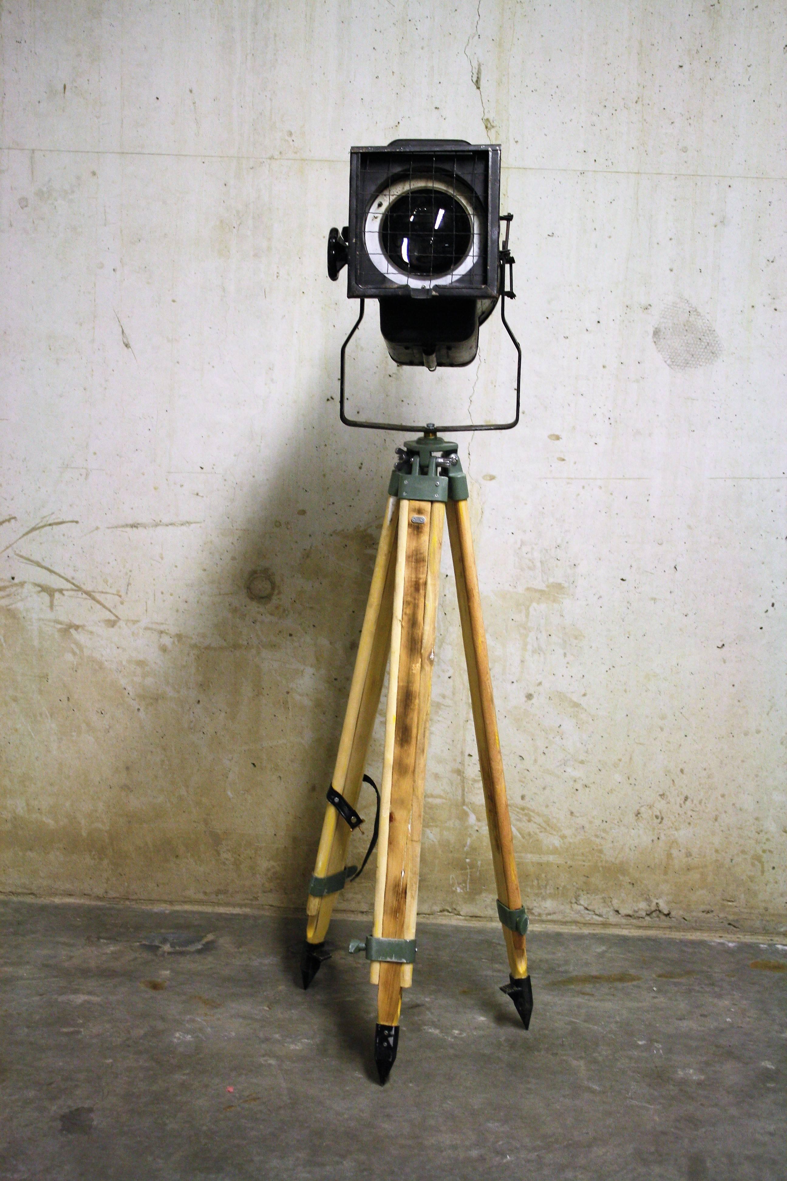Vintage theater lamp on a wooden tripod.

This unique floor lamp looks great with modern day furniture, but will fit in perfectly in a vintage interior as well.

The height of the tripod is adjustable and the spot can be turned and set to shine