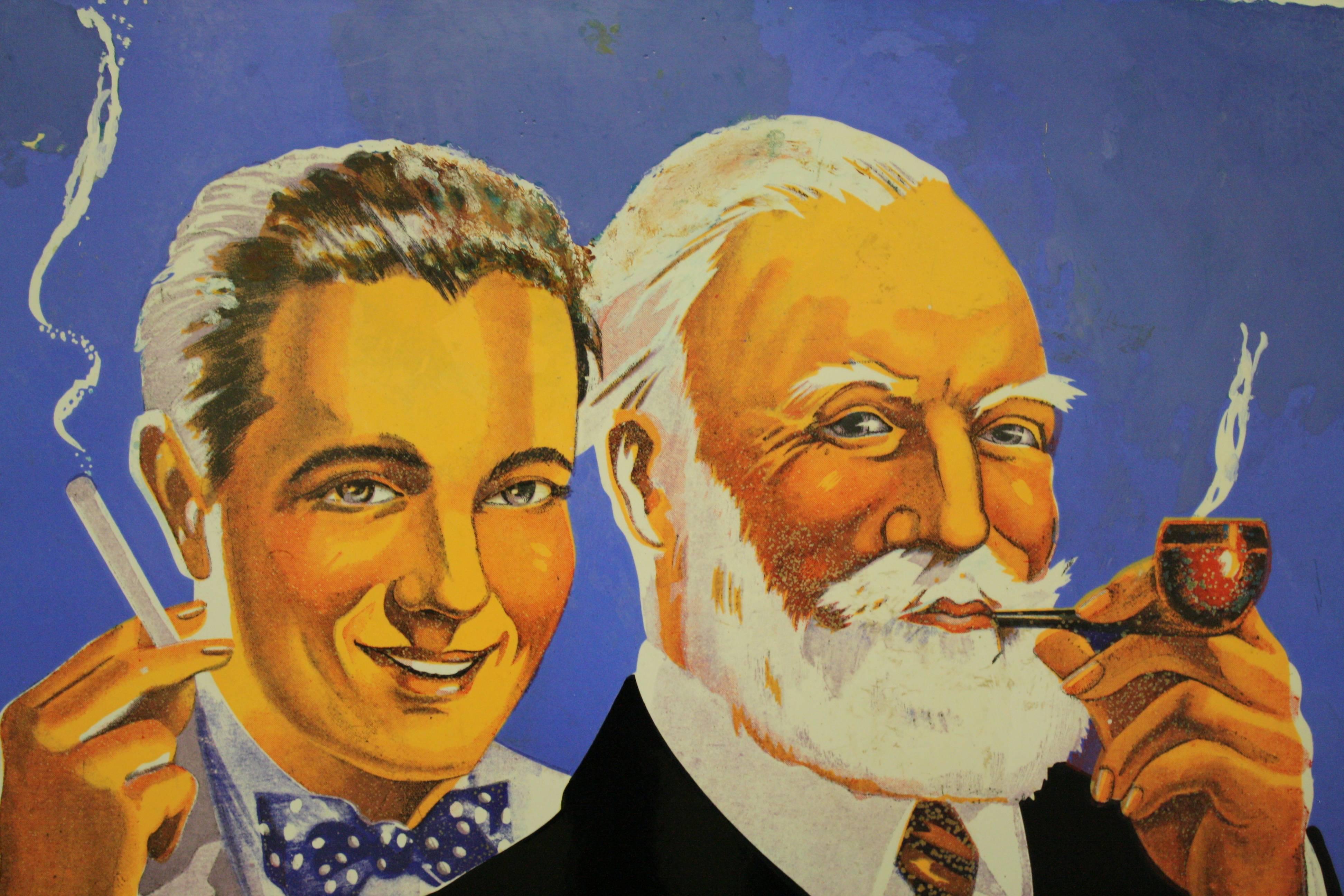 Beautiful tobacco advertising sign 'AJJA'.

The sign is made from enameled metal and has some slight wear.

The image of the two man casually smoking with a happy expression makes the sign so lively.

This type of advertising would be