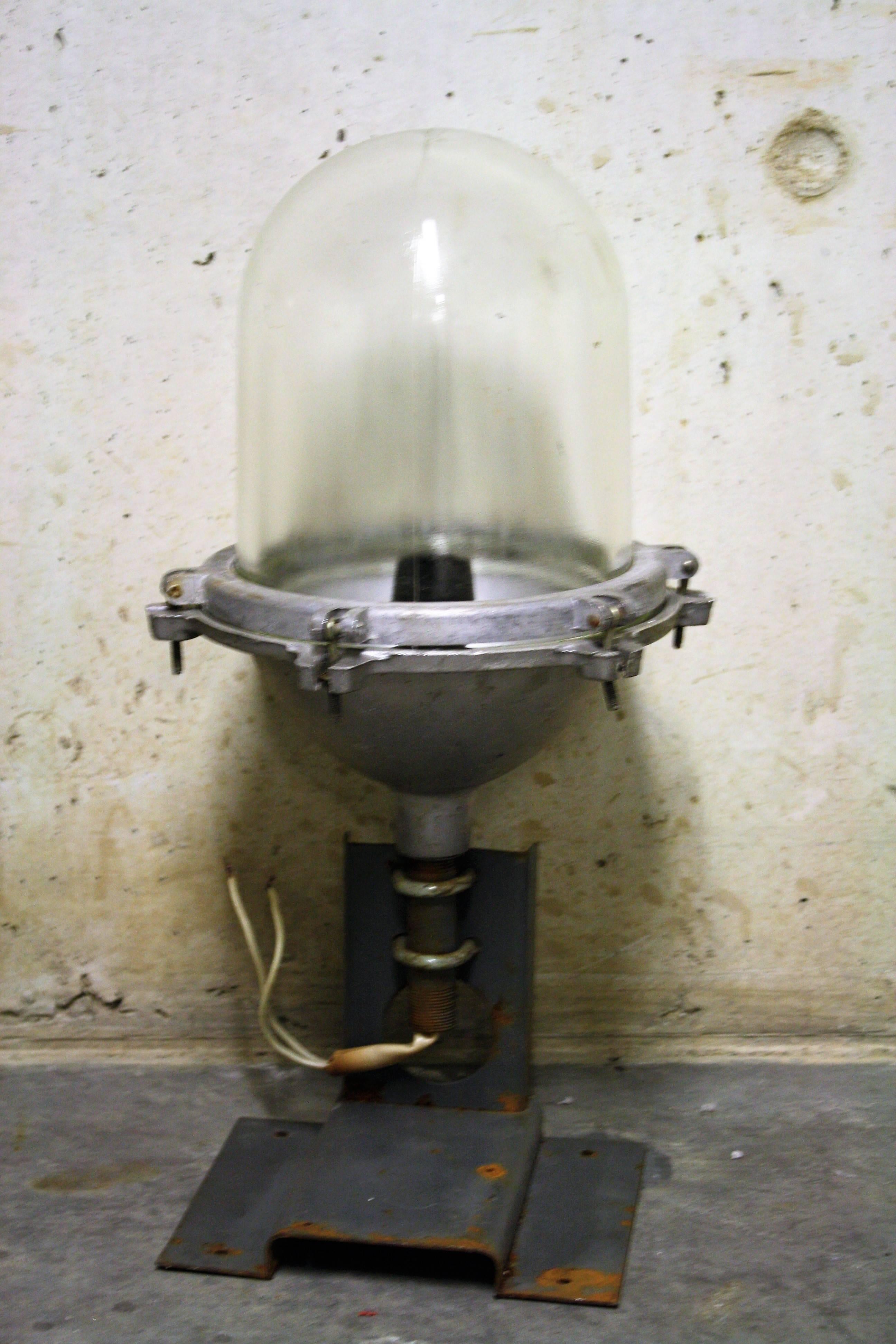Pair of cast iron explosion proof Industrial bully lamps.

These lamps where commonly used in chemical factories and are made of very thick glass.

These USSR examples have a very 'heavy duty' Industrial look.

The lamps come with their