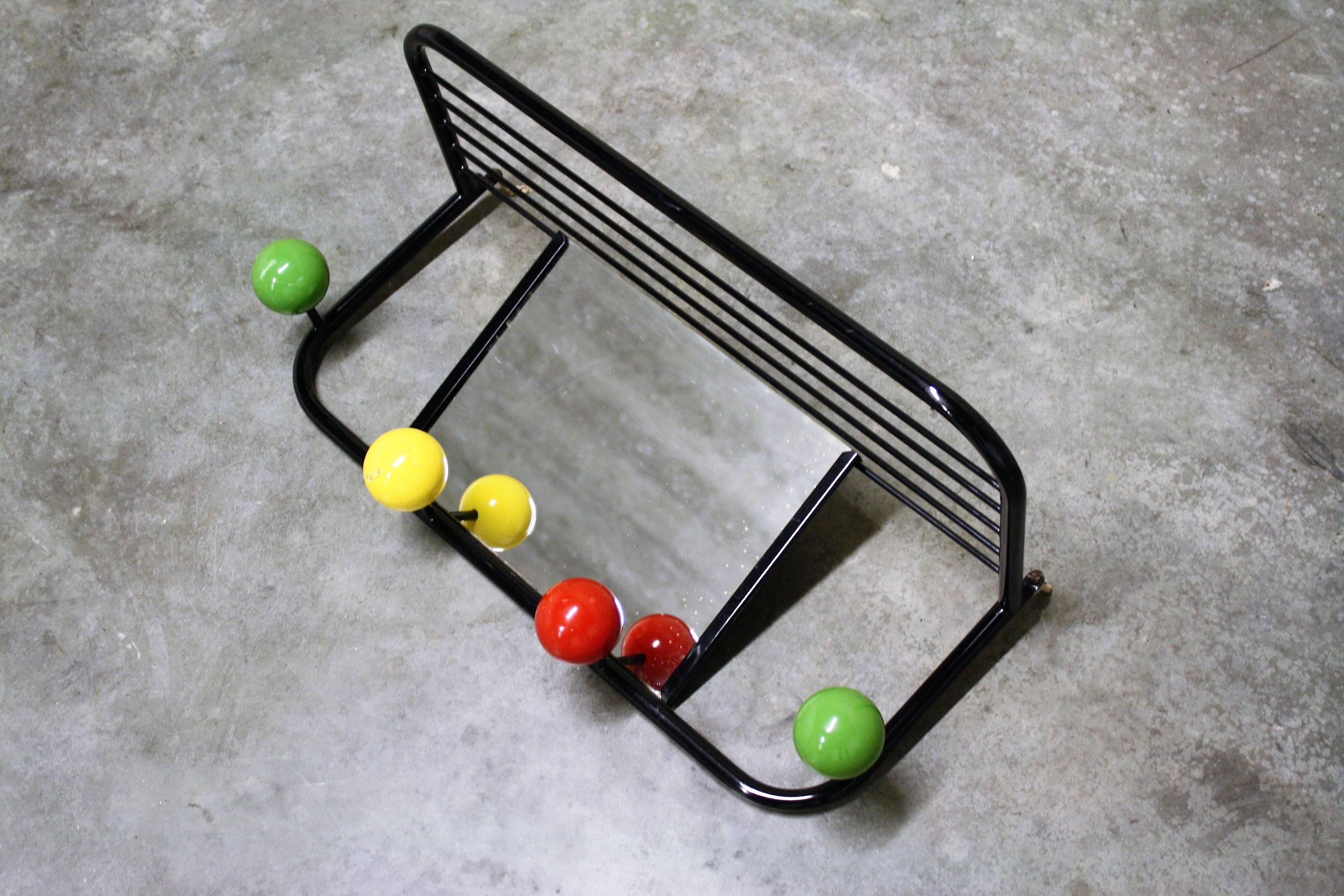 Vintage atomic coat rack in the style of Roger Feraud.

The typical Space Age atomic design still looks modern today.

It consists of a mirror, four coloured wooden balls and a tray that serves for hats or other attributes.

Lovely add-on for