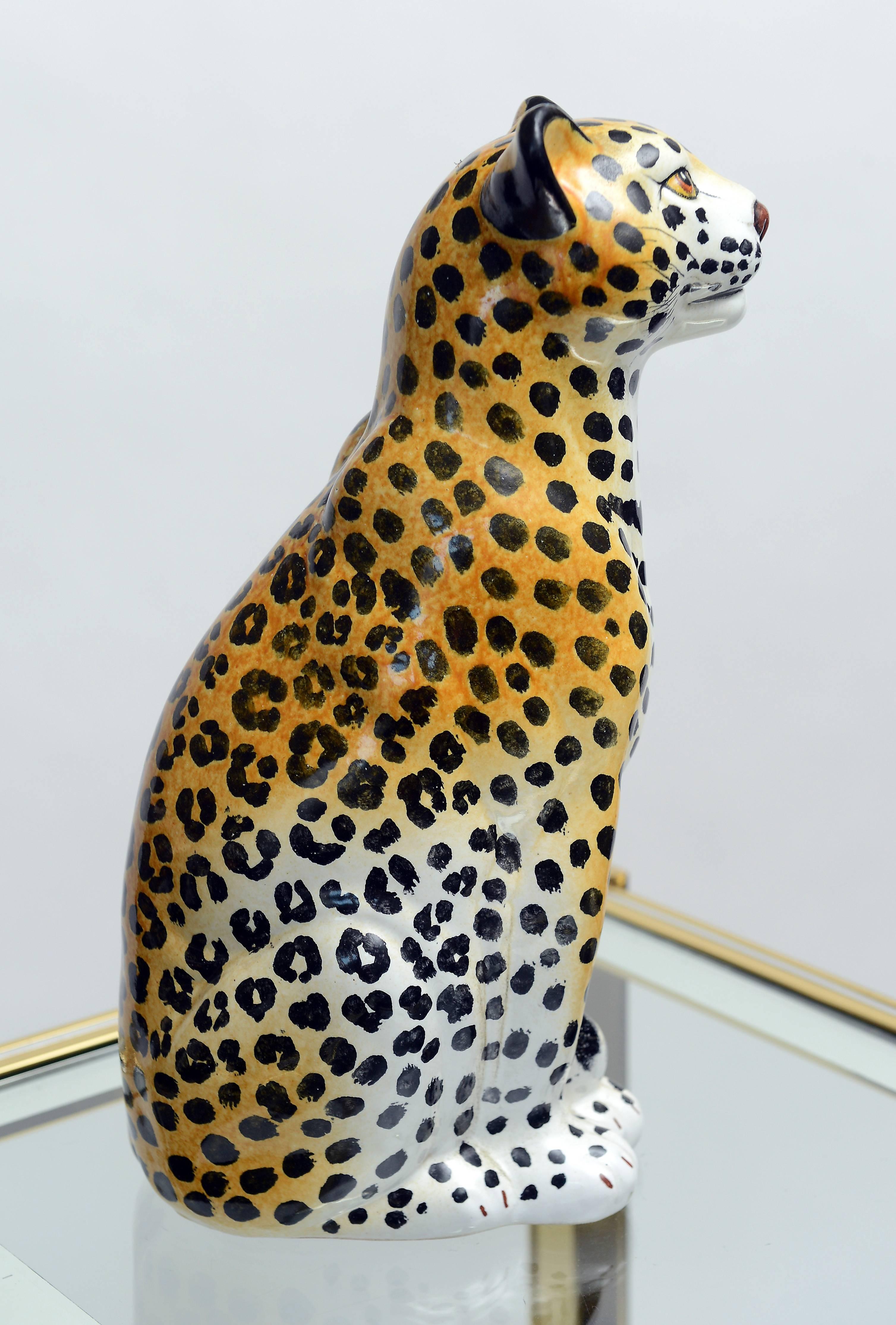 An Italian vintage sculptural leopard, produced circa 1970s, made from glazed ceramic, depicted sitting upright,

Markings include stamp [Made in Italy] on the base. 

Good vintage condition, 

Measures: Height 40cm (16")

Italy, 1970s.