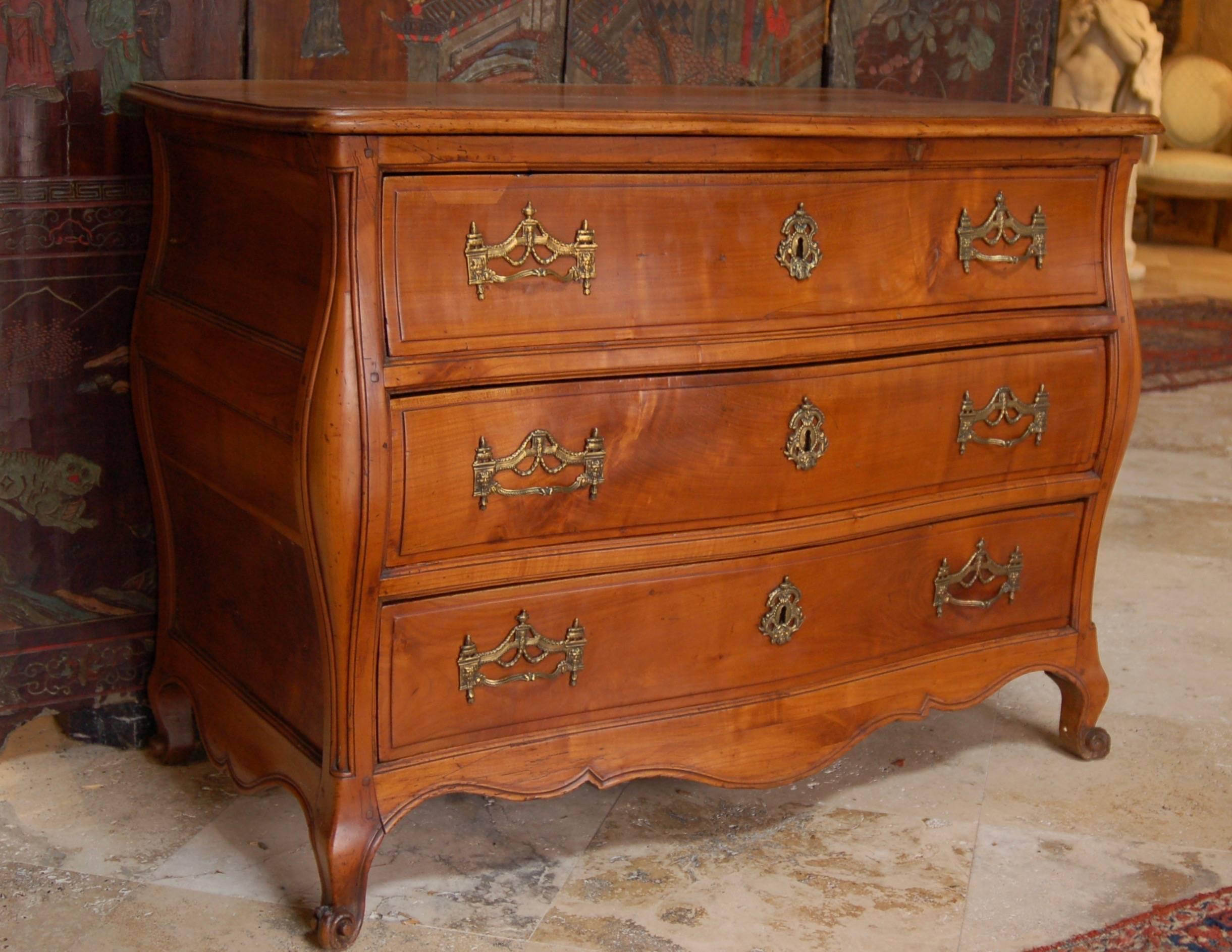 Louis XV period French Bombay commode in solid cherry from Bordeaux, original bronze pulls, exceptional color and design.