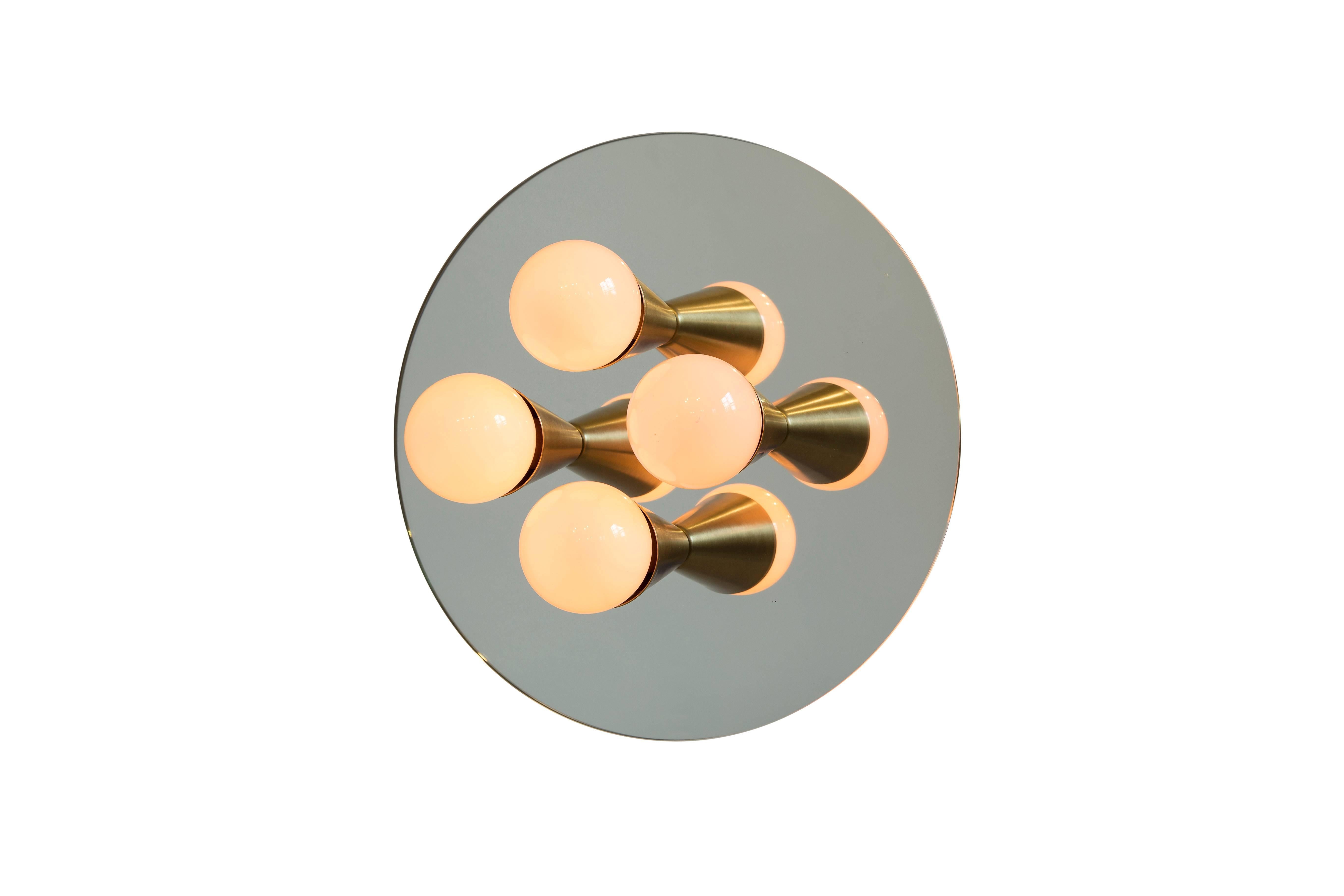 This listing is for a pair of the Echo four sconces. The price includes two lights.

Simple, elegant and playful, the Echo Series is a line of surface-mount fixtures that can be used on a wall or ceiling. White or brass cones mount to mirrored