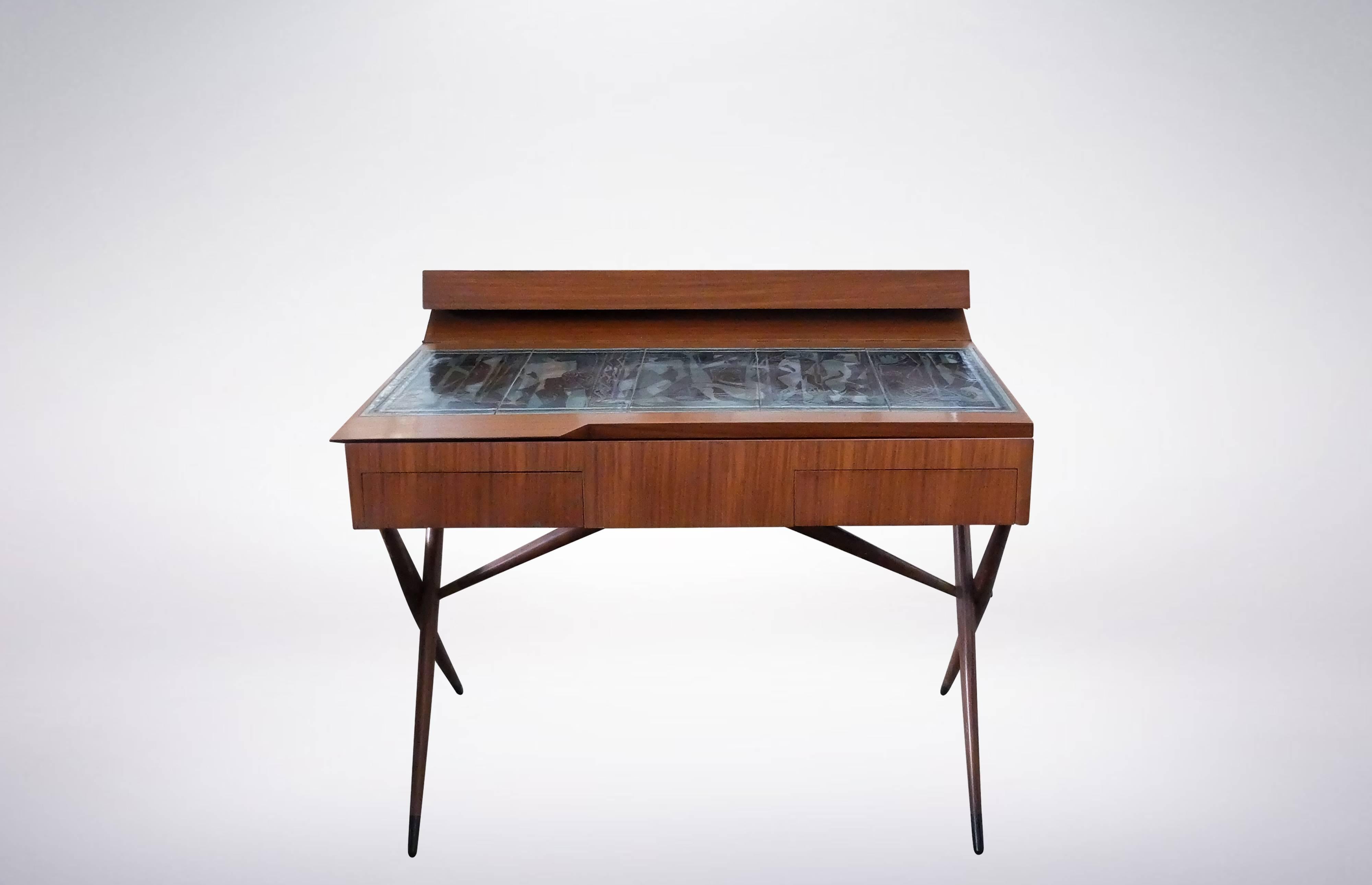 Dresser with open-top stowaway, designed by Ico & Luisa Parisi for Altamira in 1942. 
The table-top was realized in enameled copper by Paolo de Poli based on the designs of Pietro Zuffi. 
The top opens to expose storage space, and was decorated with