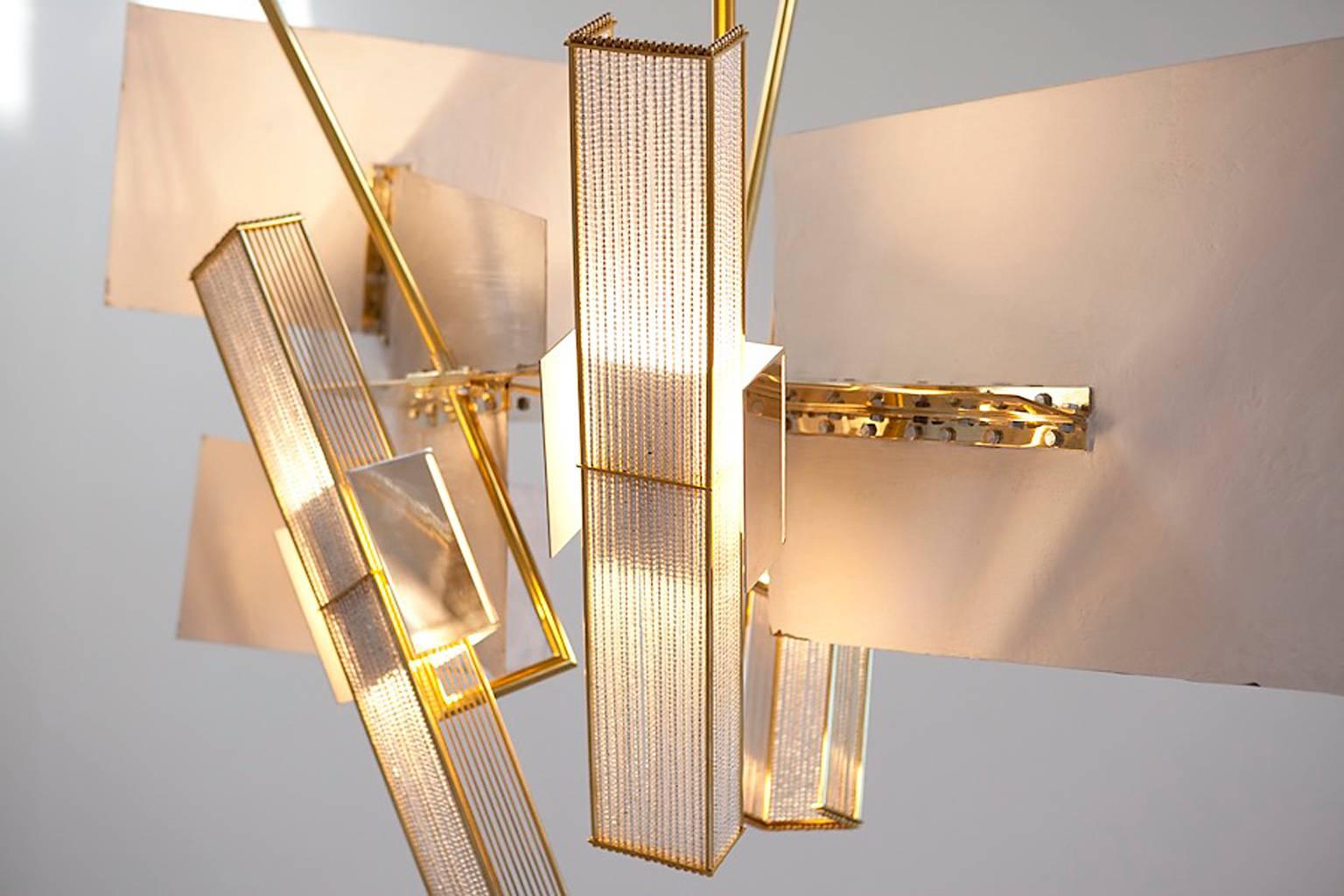 This one-of-a-kind light sculpture was created as the focal point for an ultra modern penthouse apartment in New York. Using fine Japanese mirror beads, this piece incorporates silver and gold plated details and has an industrial yet tailored