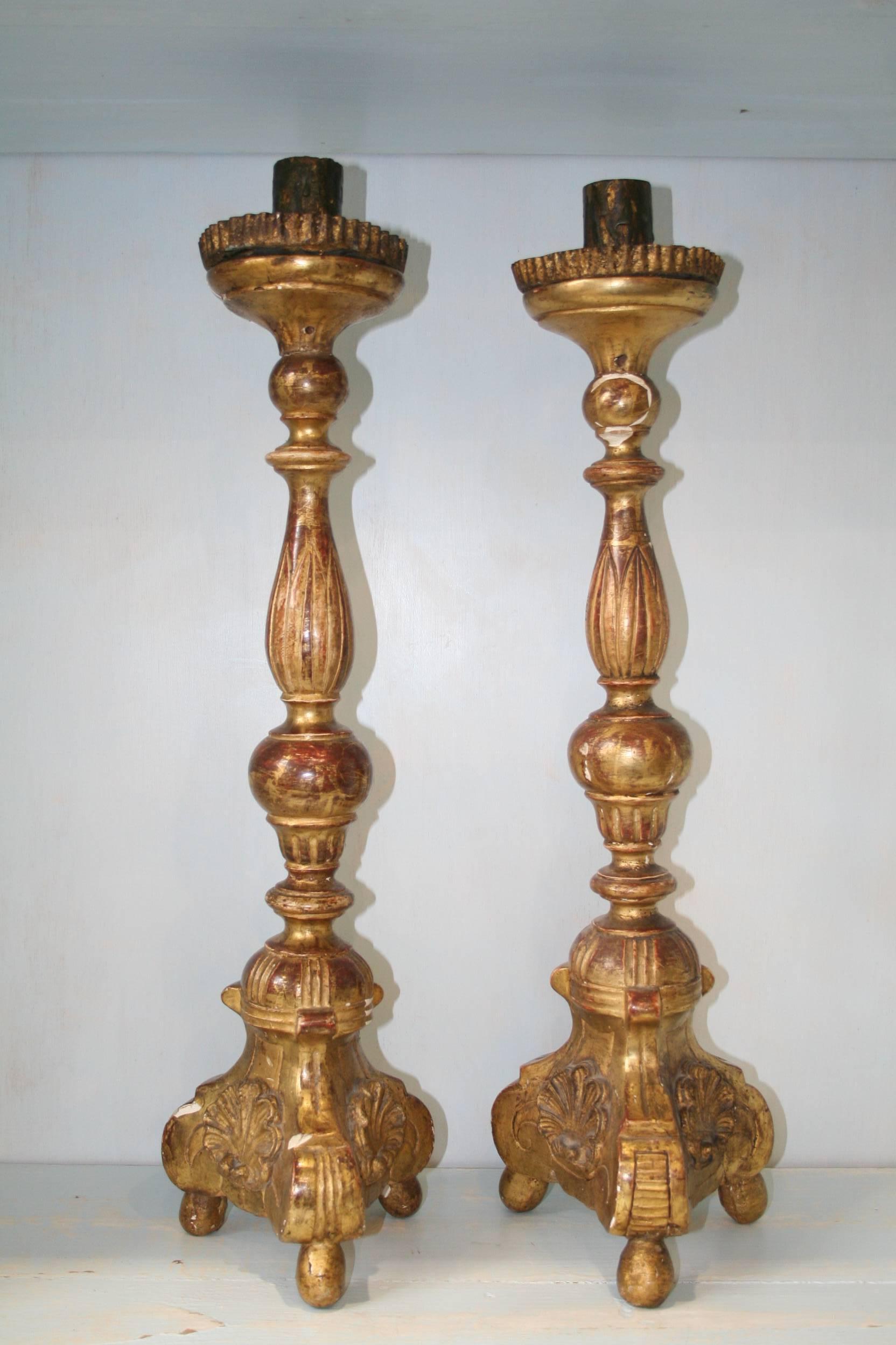 Pair of 18th century Italian candleholders in wood with their original golden patina.