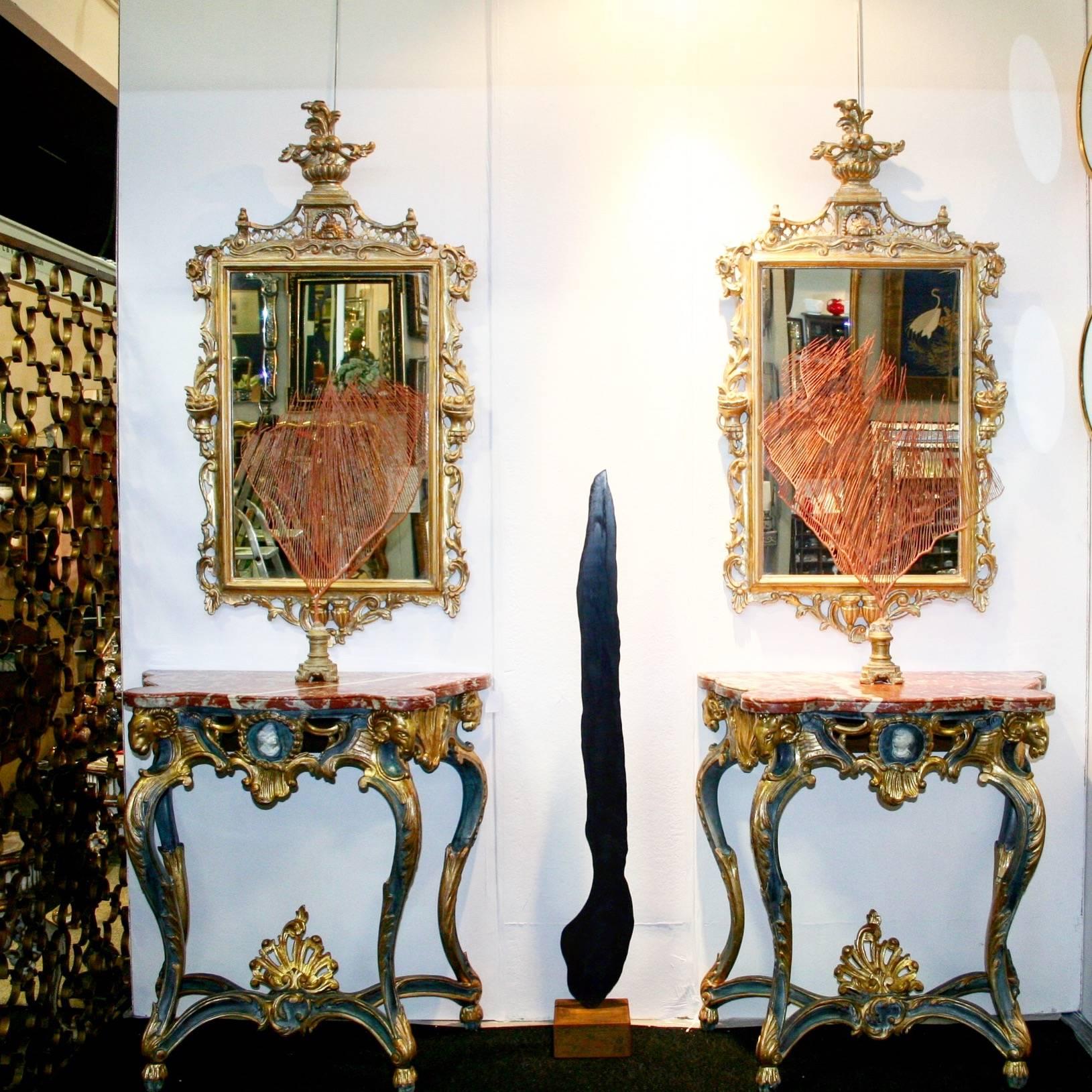 Pair of early 19th Century consoles. Polychromed. With rams at the four ends. Original marble.