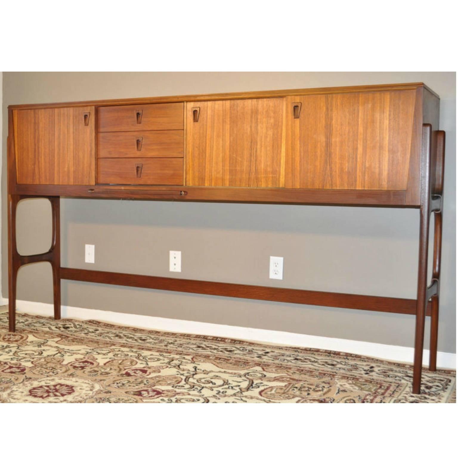 Made by Elliots of Newbury, this amazing “Stow-a-way” shows the ingenuity of getting so much out of smaller areas but still keeping with the quintessential Danish design.

Both table and chairs tuck under the credenza, when not needed, and fold