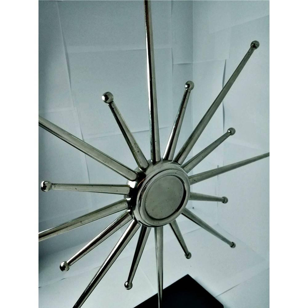 This starburst clock is made out of heavy steal. Each individual starburst screws off to make for easy and convenient shipping. The clock is mounted into a thick piece of black marble slab. It would look fantastic anywhere in your home. Super
