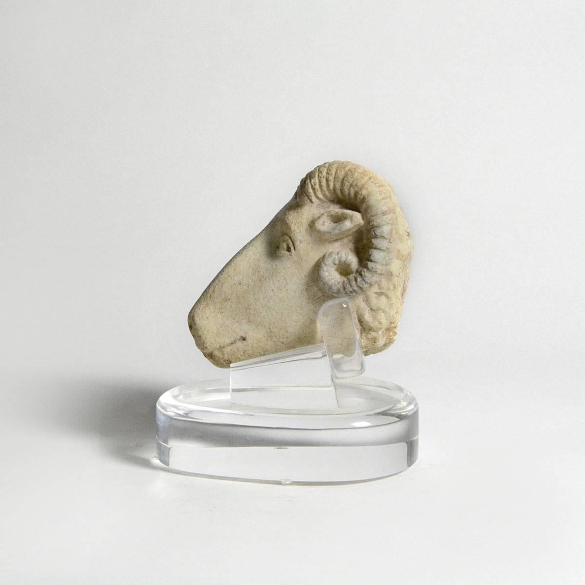 This well-modeled head of a ram captures the essence of the animal with the articulated ridge running across the top of its snout. This feature gives prominence to its nostrils and mouth. Its eyes are carefully modeled as are its horns and