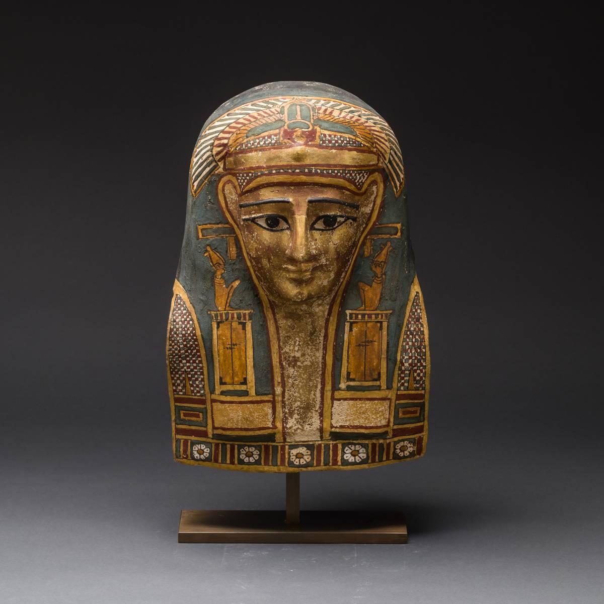 This well-preserved mummy mask was created from cartonnge, a kind of ancient Egyptian papier mâché in which layers of linen or recycled papyrus were combined with gesso, a type of plaster, in order to be modelled into a mummy mask used to cover