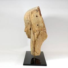 Fragment of an Egyptian Wooden Sarcophagus Depicting a Head