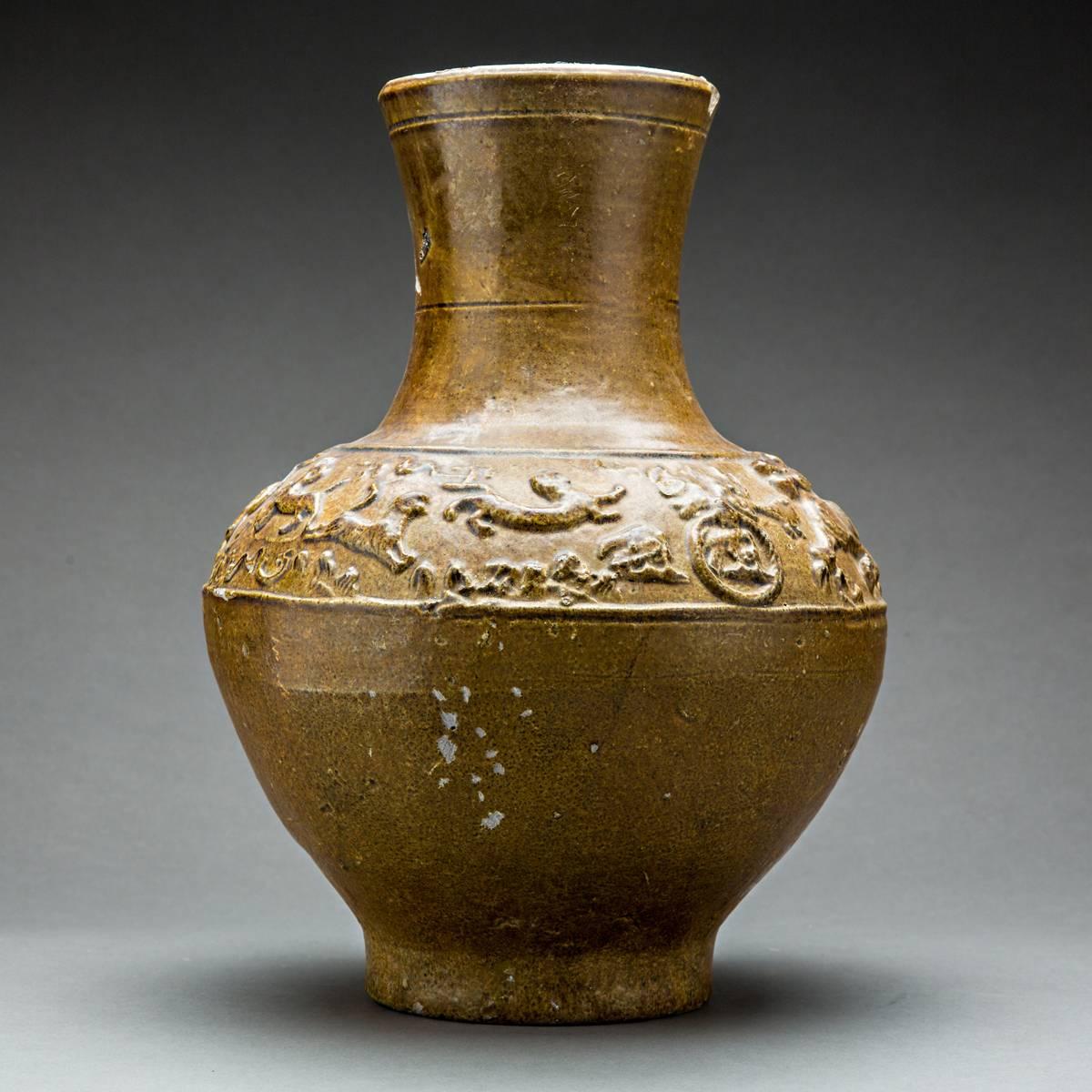Buff earthenware with moulded decoration and straw-coloured lead glaze.

Similar in shape to contemporary bronze Hu vases , lead glazed ceramic versions emerged in Shaanxi during the second century BCE, mostly to replace their metal prototype in