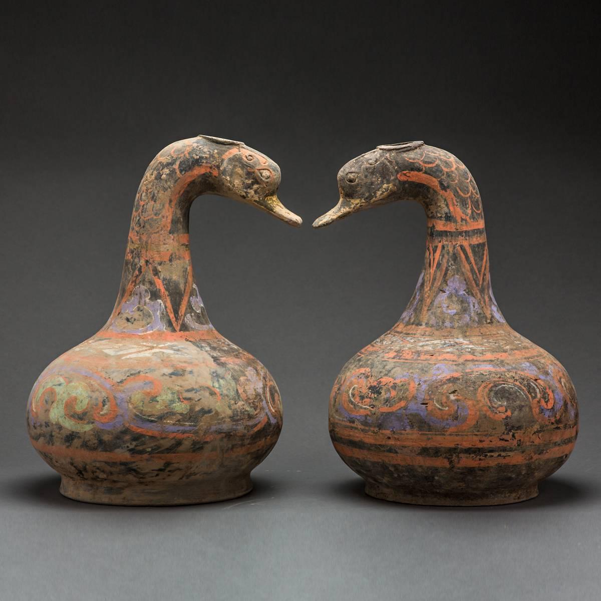 These highly unusual vessels are funerary containers, that were interred with a deceased person of considerable social standing in order to aid their passage into the hereafter. The Han period is known for extensive sociopolitical change followed by