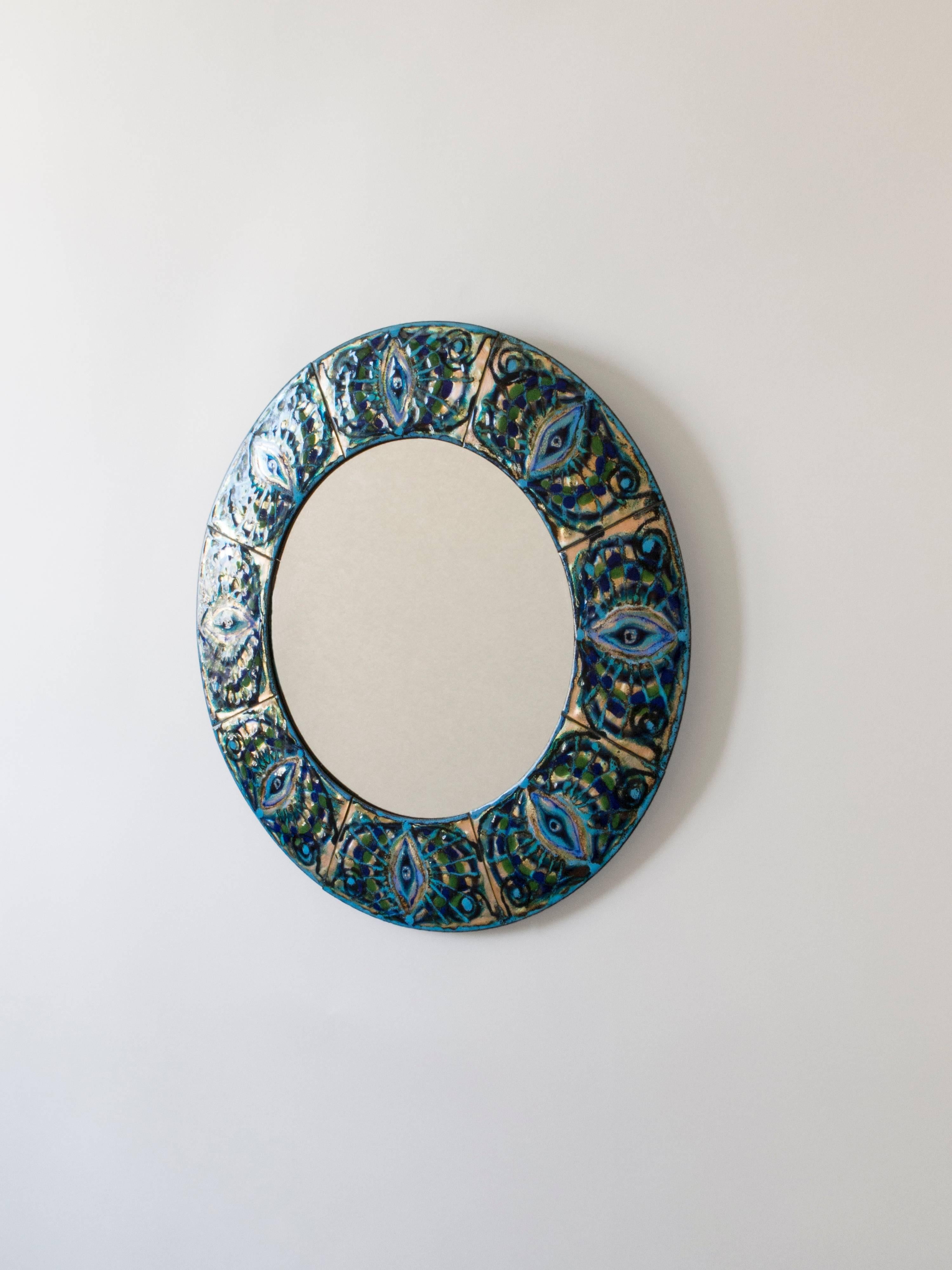 Composed of enameled copper plates hand-painted by the Danish artist Bodil Eje. The repeating pattern displays vivid turquoise, cobalt, green and colorless enamel, surrounding a colorless glass mirror plate. 

A vivid little jewel in great