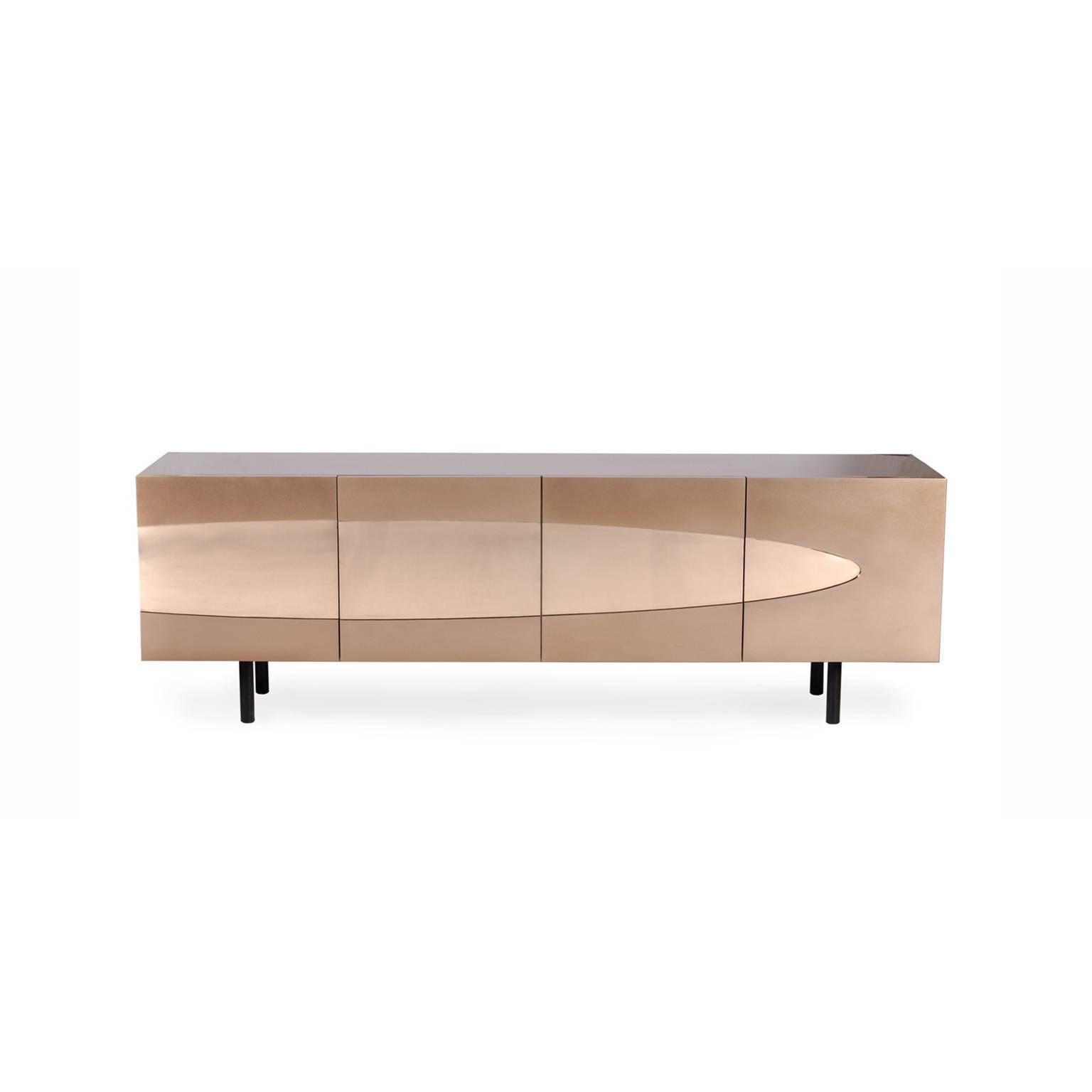 The Ellipse sideboard in bronze is an artistic luxurious piece built to satisfy bronze lovers. This four door, two-drawer contemporary cabinet is entirely clad in bronze, with a sleek Venetian red lacquered interior and genuine ebony legs.

This