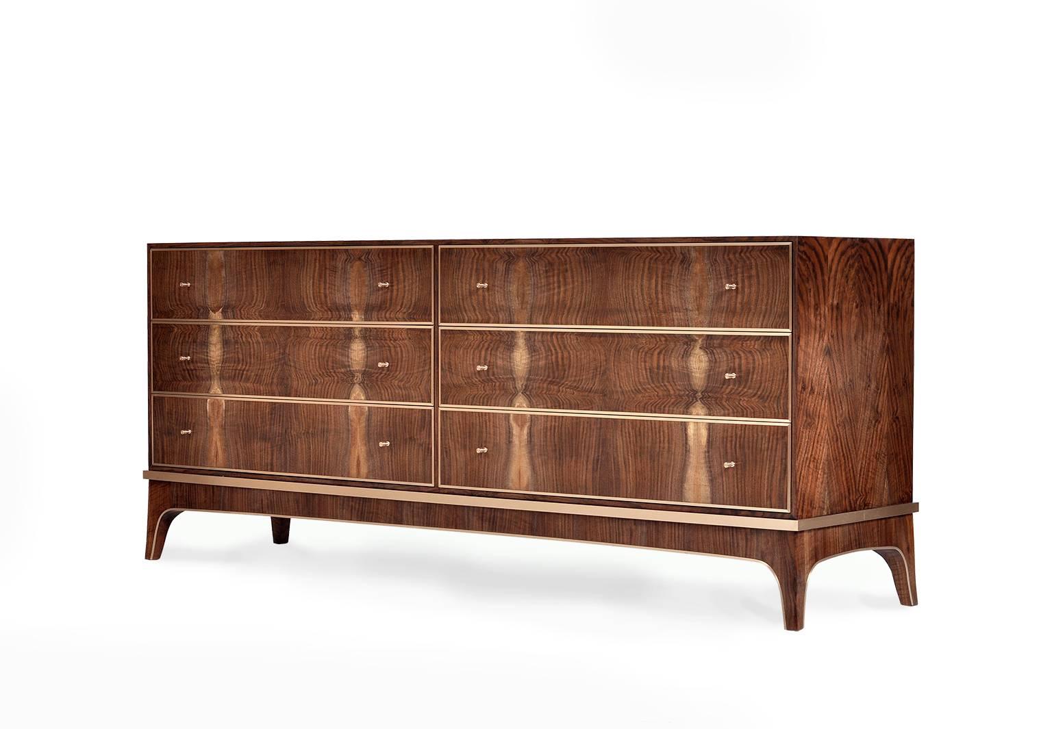 The Reve dresser in Bastogne walnut and bronze is a beautiful, rich example of modern elegance. 

This six-drawer piece is made using our shop sawn veneer, giving a thickness and authentic luxury that most modern furniture cannot boast. We carefully