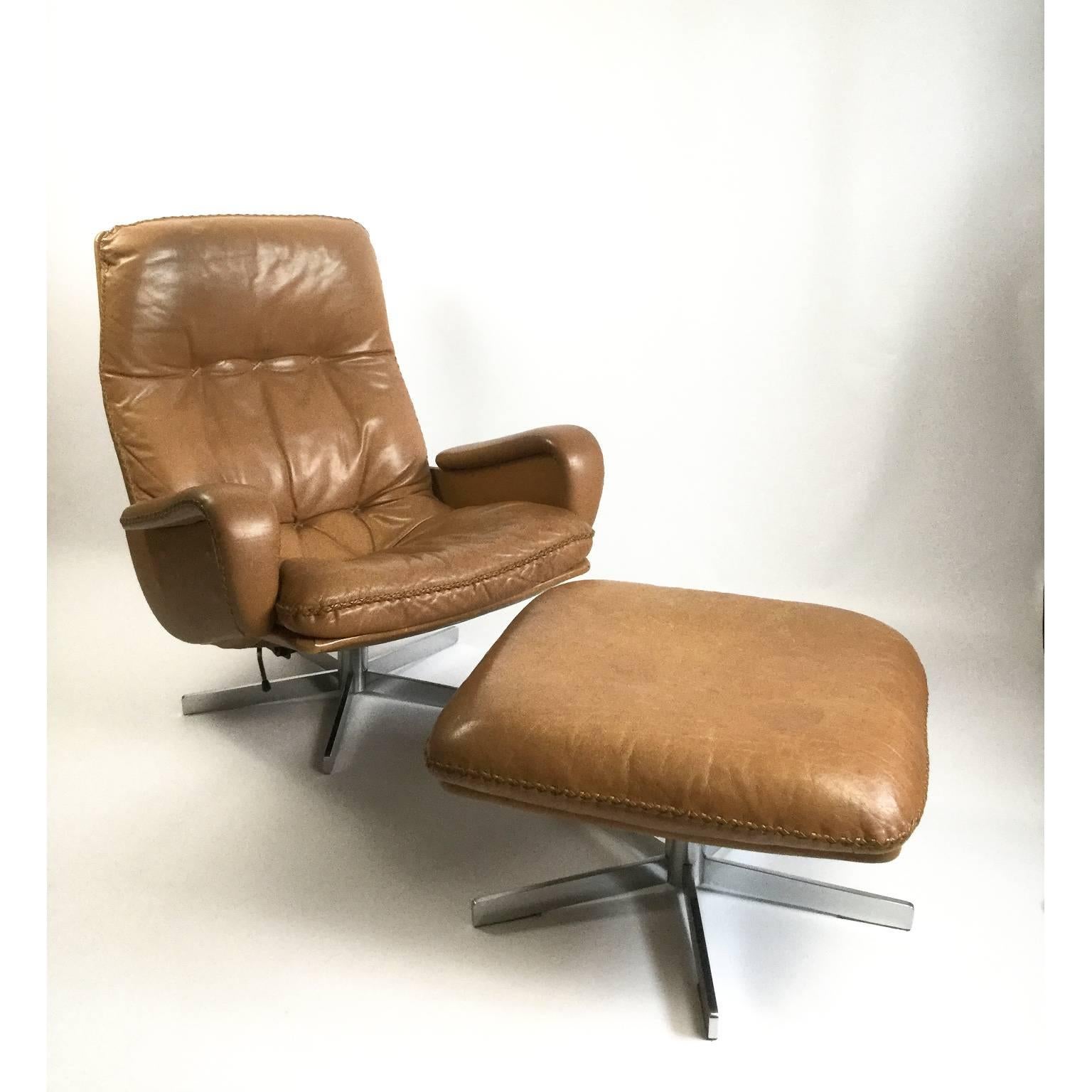 Pair of De Sede s231 swivel leather lounge armchairs with an ottoman.
Manufactured in 1960s by the well-known furniture maker De Sede in Switzerland.
The same model s231 was used as prop in 1969 in the James Bond film:
Her Majesty's Secret
