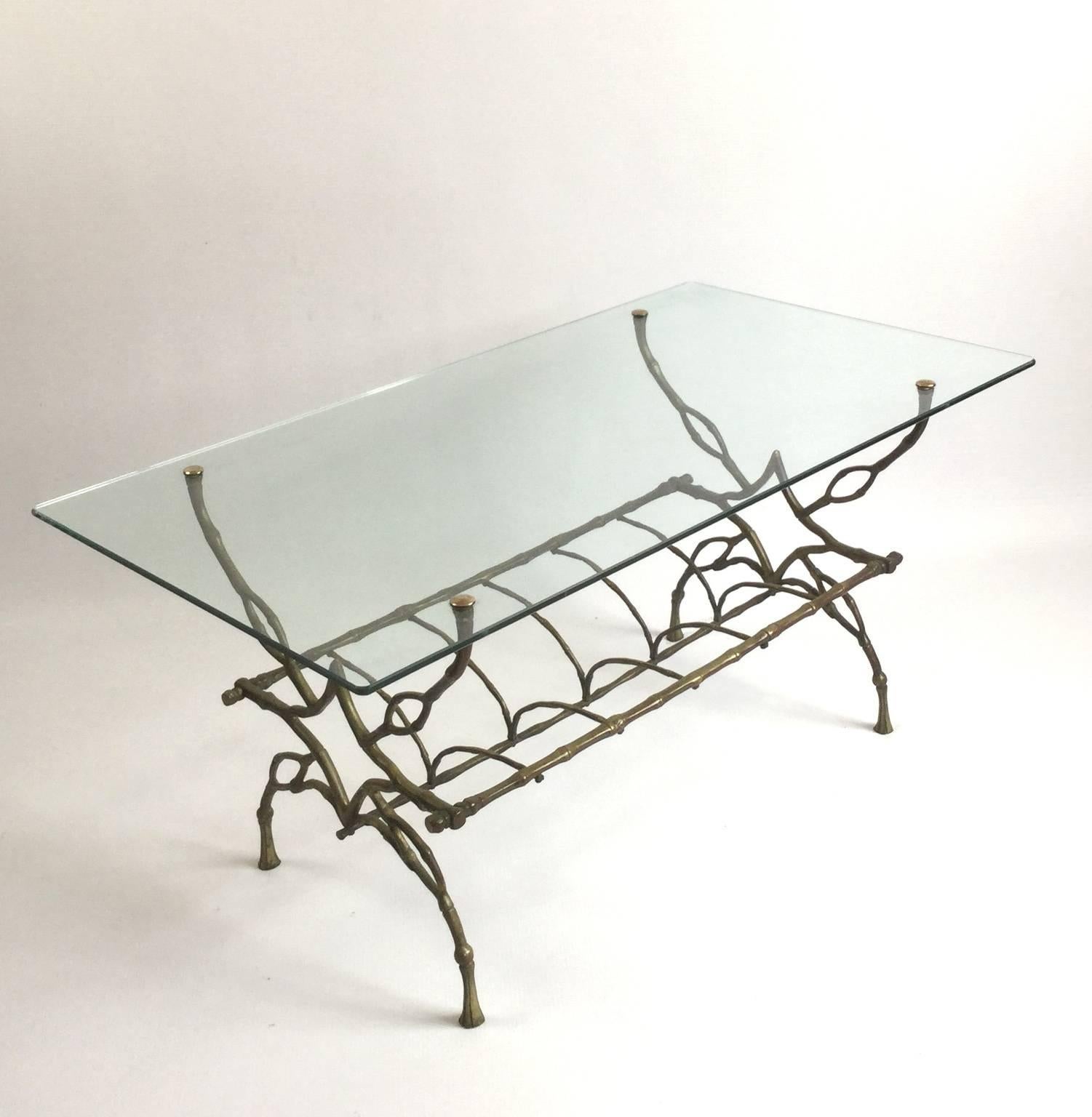 Amazing good quality faux bamboo bronze coffee table with a spine skeleton shape.
Rectangular glass top and bronze newspaper holder.
In the style of Maison Jansen or Maison Baguès.