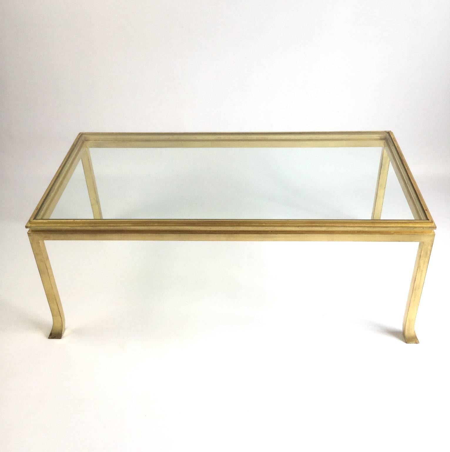 Gilt patinated metal coffee table with original rectangular high quality top glass.