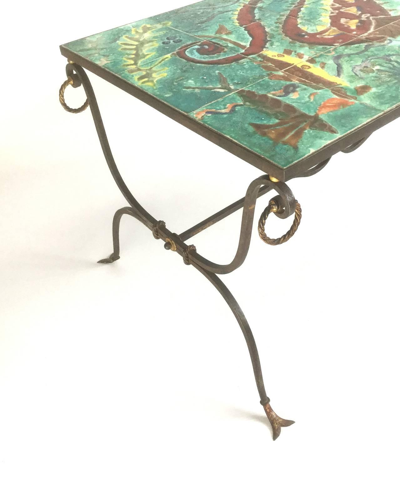 Unique French wrought iron coffee table with original tiles representing a seahorse and a seabed
This wrought iron base is a fine work, close to the French master of wrought iron technique Gilbert Poillerat 1902-1988
Delicate finish with fishtail
